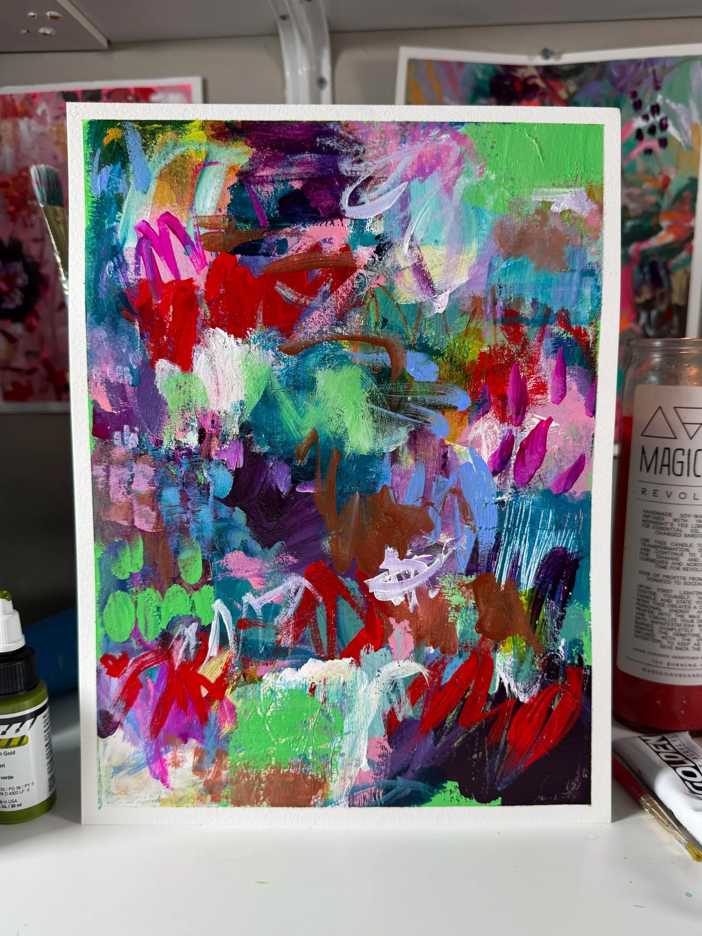 Colorful abstract painting with various brushstrokes and vibrant colors, featuring green, purple, red, blue, and white.
