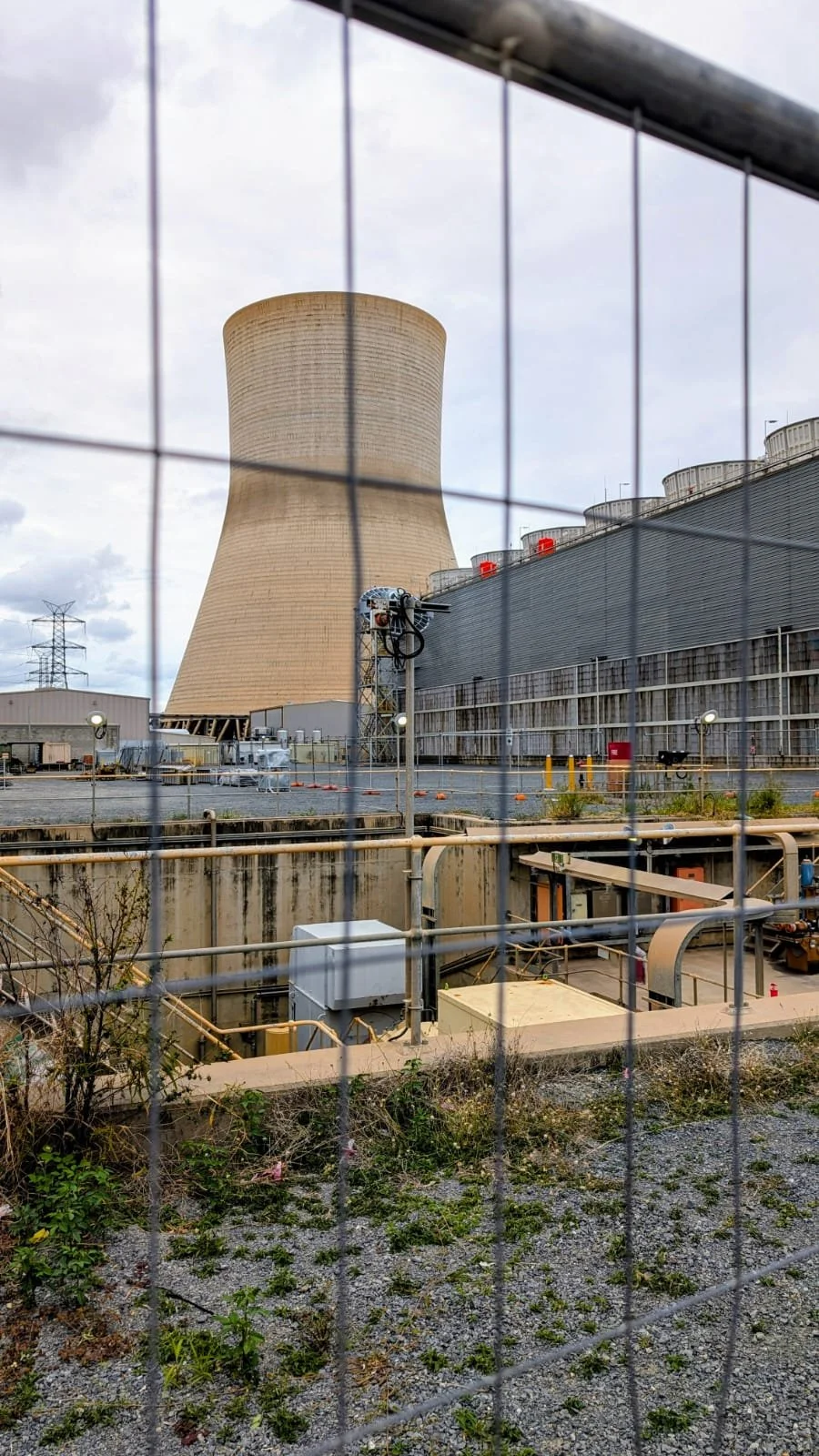 A professional technical team conducting authorized CTI ATC-105 and STD-201 performance audits on massive industrial power station towers and commercial HVAC units