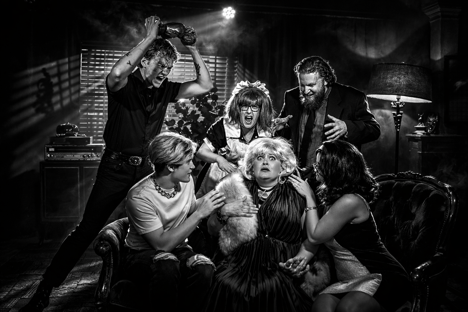 Black and white photo of six people in a tense scene, with some appearing angry and others frightened, in an indoor setting with dramatic lighting and dark furniture.