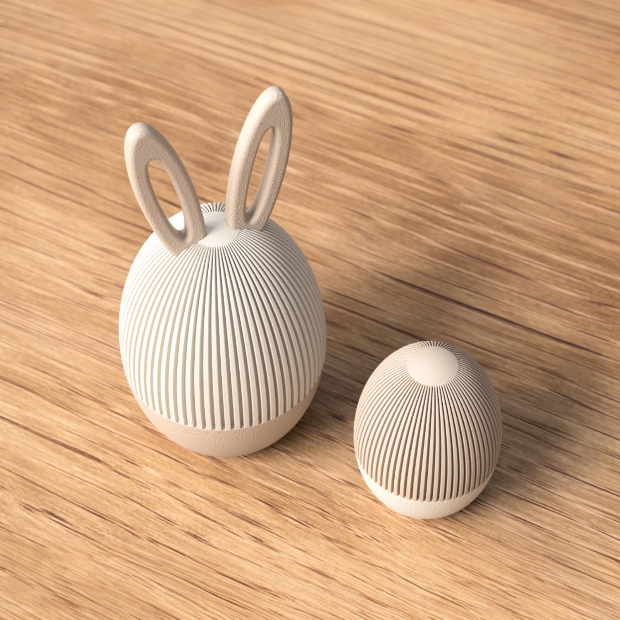 Osterei Dose mit Hasenohren neben kleinem Ei in geriffelter Struktur und sanften Naturtönen als minimalistische Osterdeko im Japandi Stil.