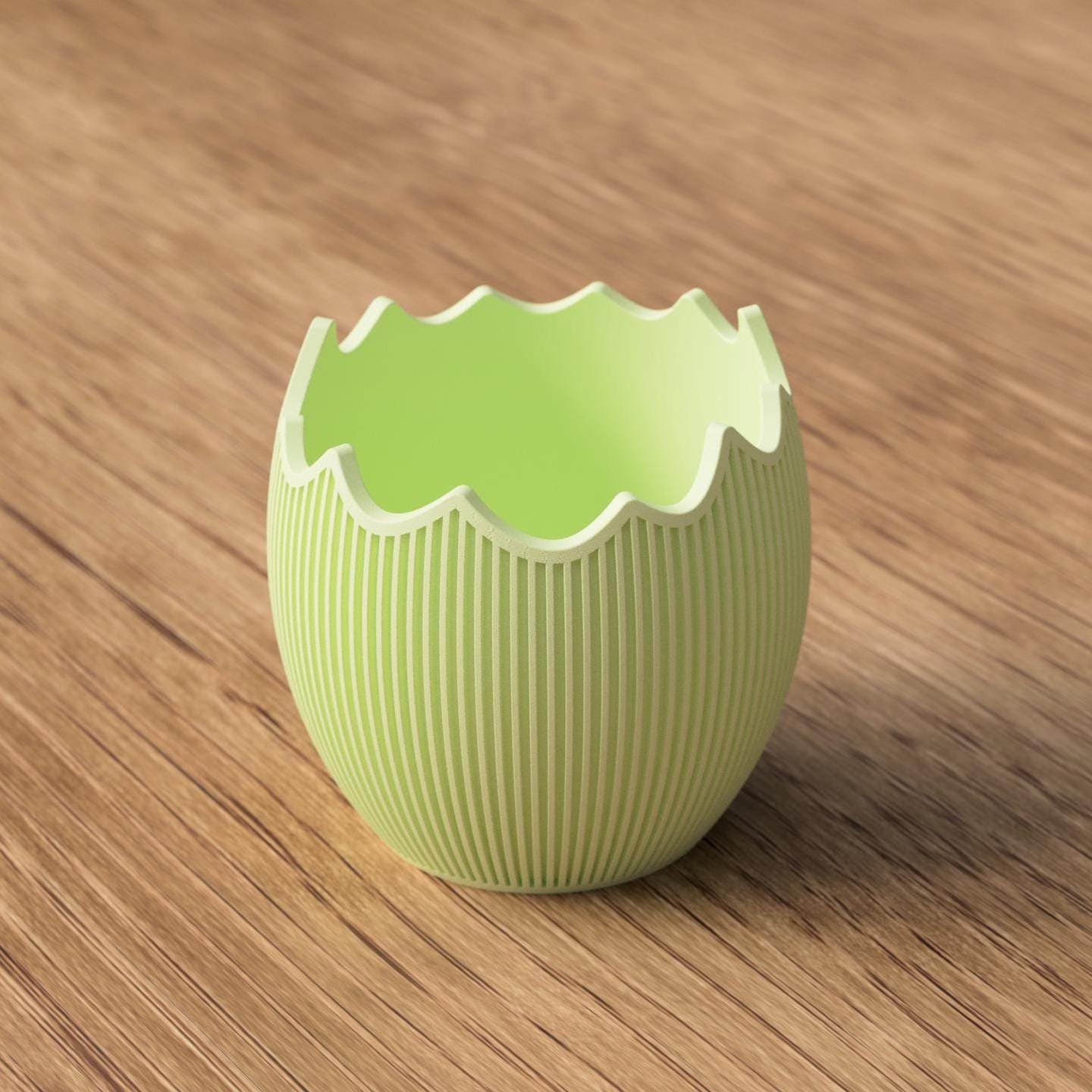 Osterschale in Hellgrün mit aufgebrochener Eierschalenform und feiner Rillenstruktur als kompakter Frühlingsakzent auf Holz.