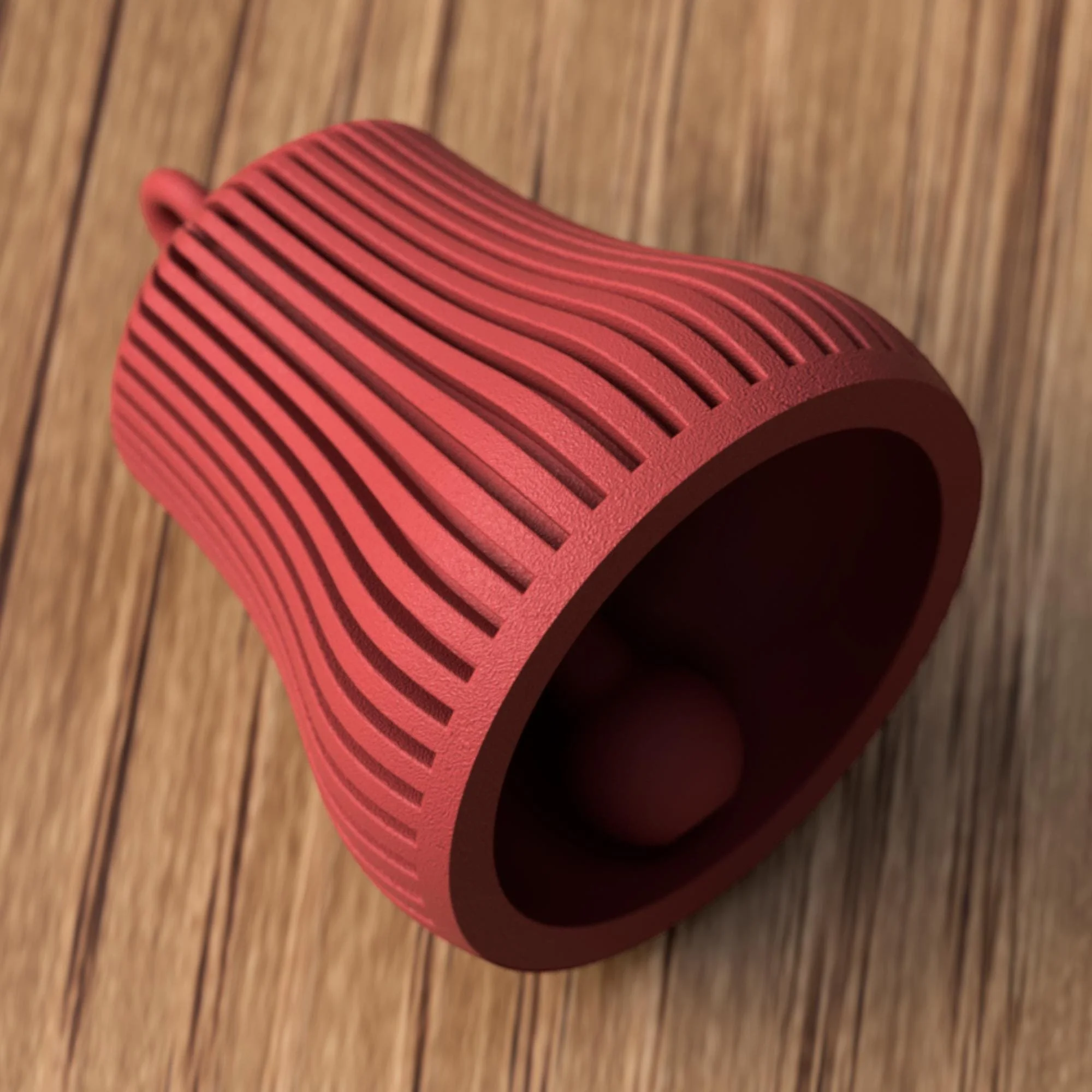 Rote Glocke liegend mit Blick ins Innere und sichtbarem Klöppel, hebt die Funktion und das Design des 3D-gedruckten Anhängers hervor