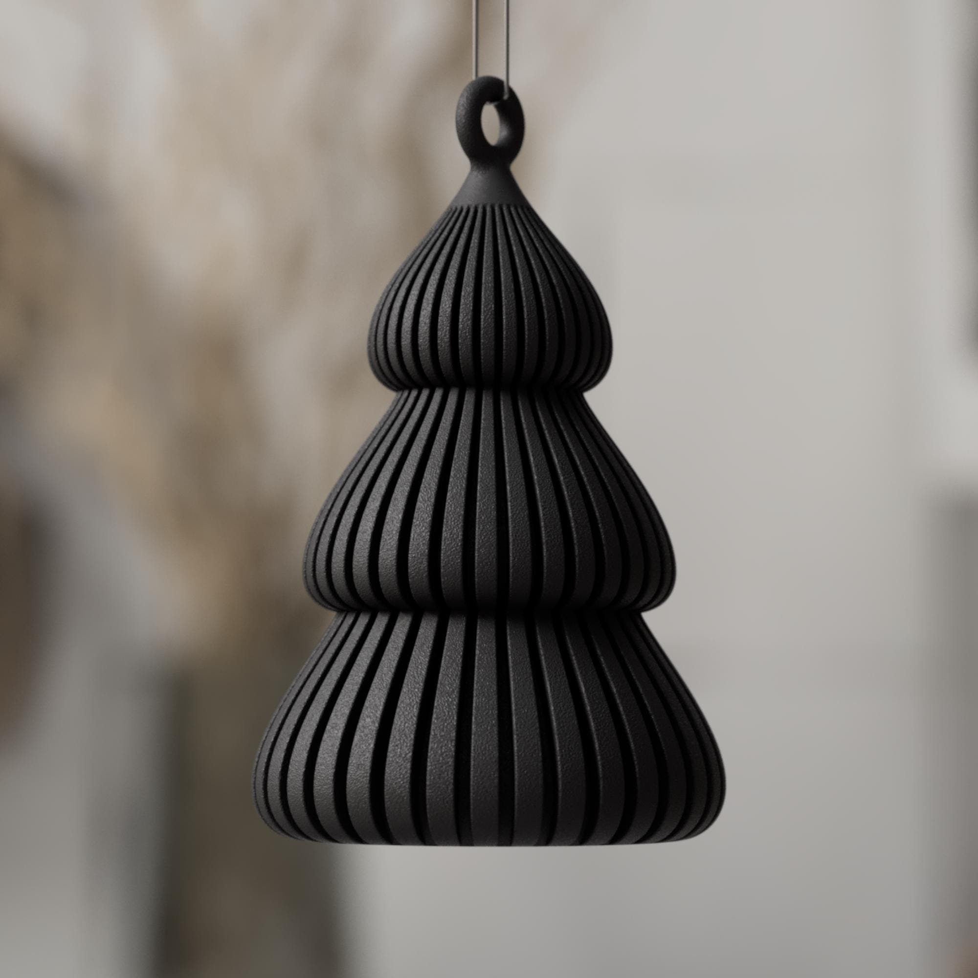 Schwarzer Christbaumschmuck in stilisierter Tannenform mit gerillter Oberfläche und runder Aufhängung, modern und kontraststark inszeniert.