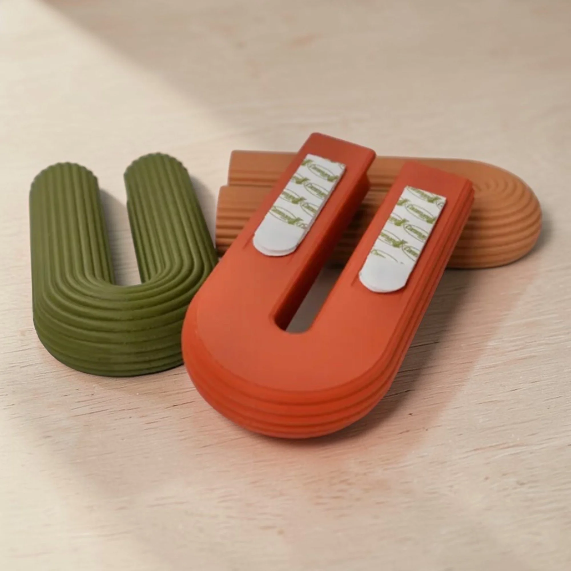 BOWIA Wandvase in Terrakotta mit eingesetztem Glasröhrchen auf hellem Untergrund, dekorativ arrangiert als minimalistischer Pflanzenhalter für die Wand.