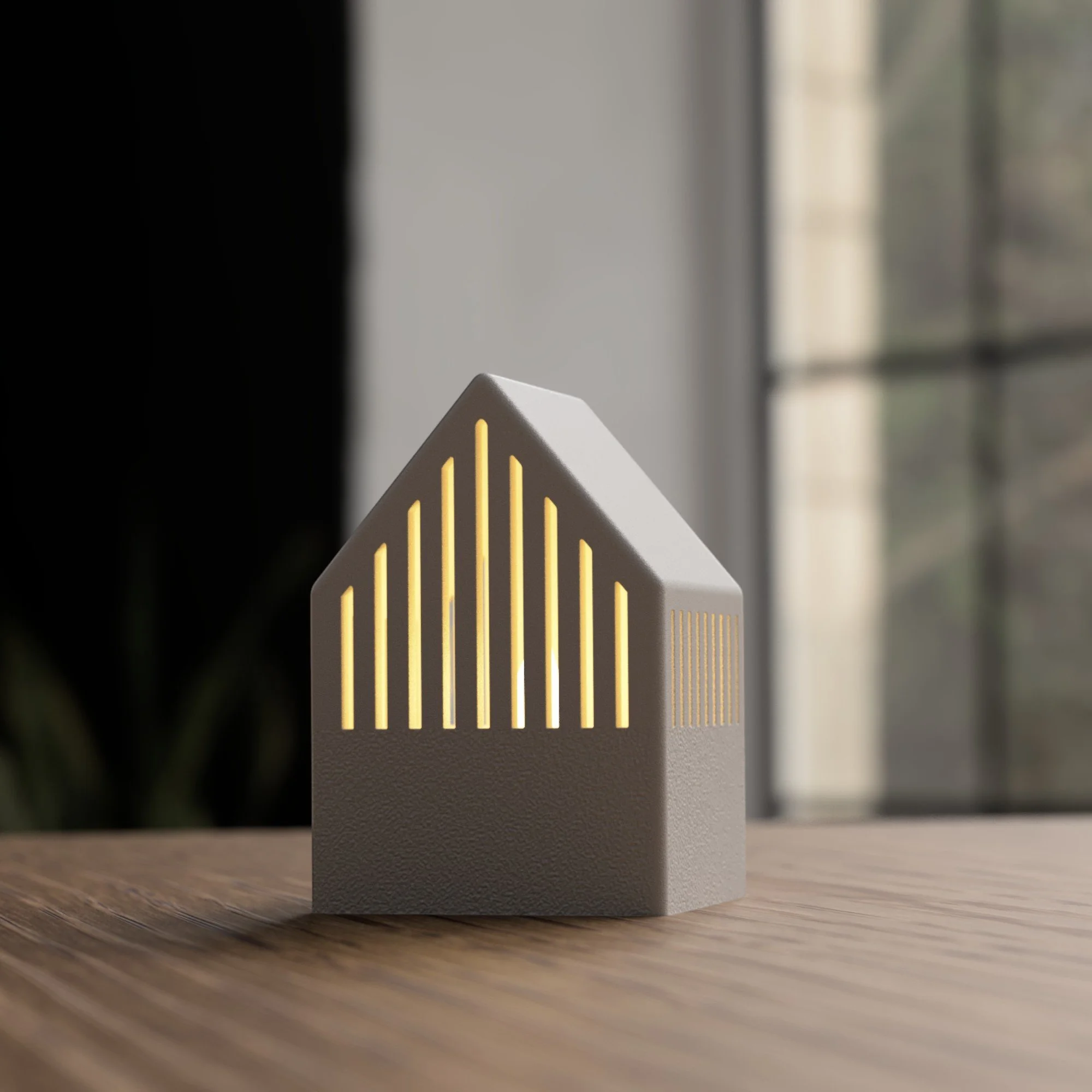 Japandi Teelichthaus in Grau mit goldenen Lichtschlitzen und hellem Dach, frontal auf Holzoberfläche als minimalistisches Wohnaccessoire.