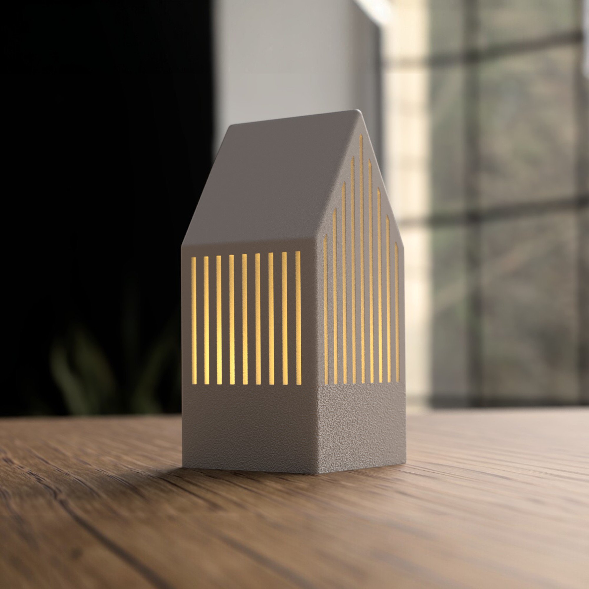 Kleines Japandi Teelichthaus in Beige mit goldenen Lichtschlitzen und weißem Dach, dekorativ auf einer Holzoberfläche platziert.