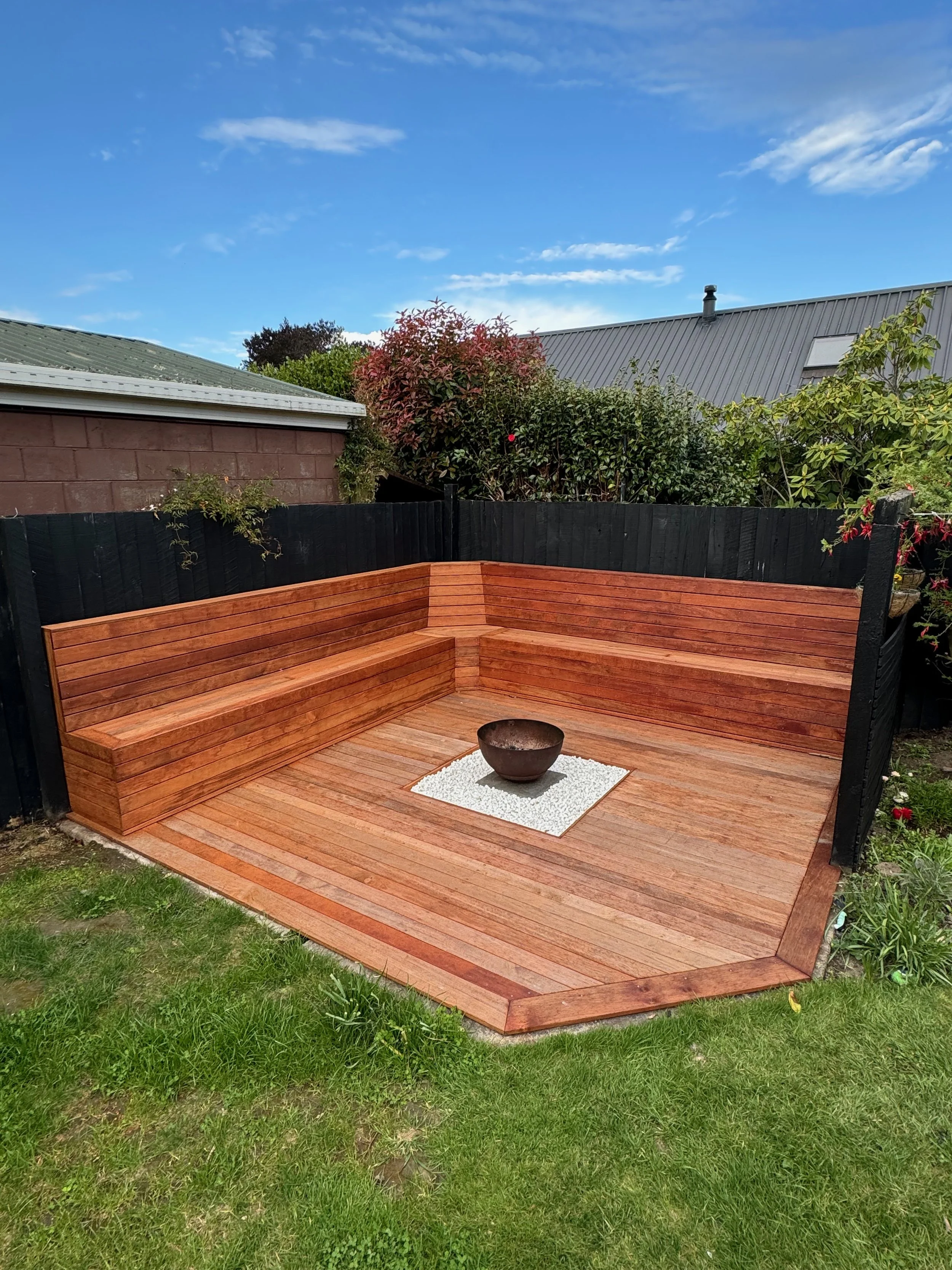 A custom firepit space with custom stacked seating for a outdoor feature in Christchurch.