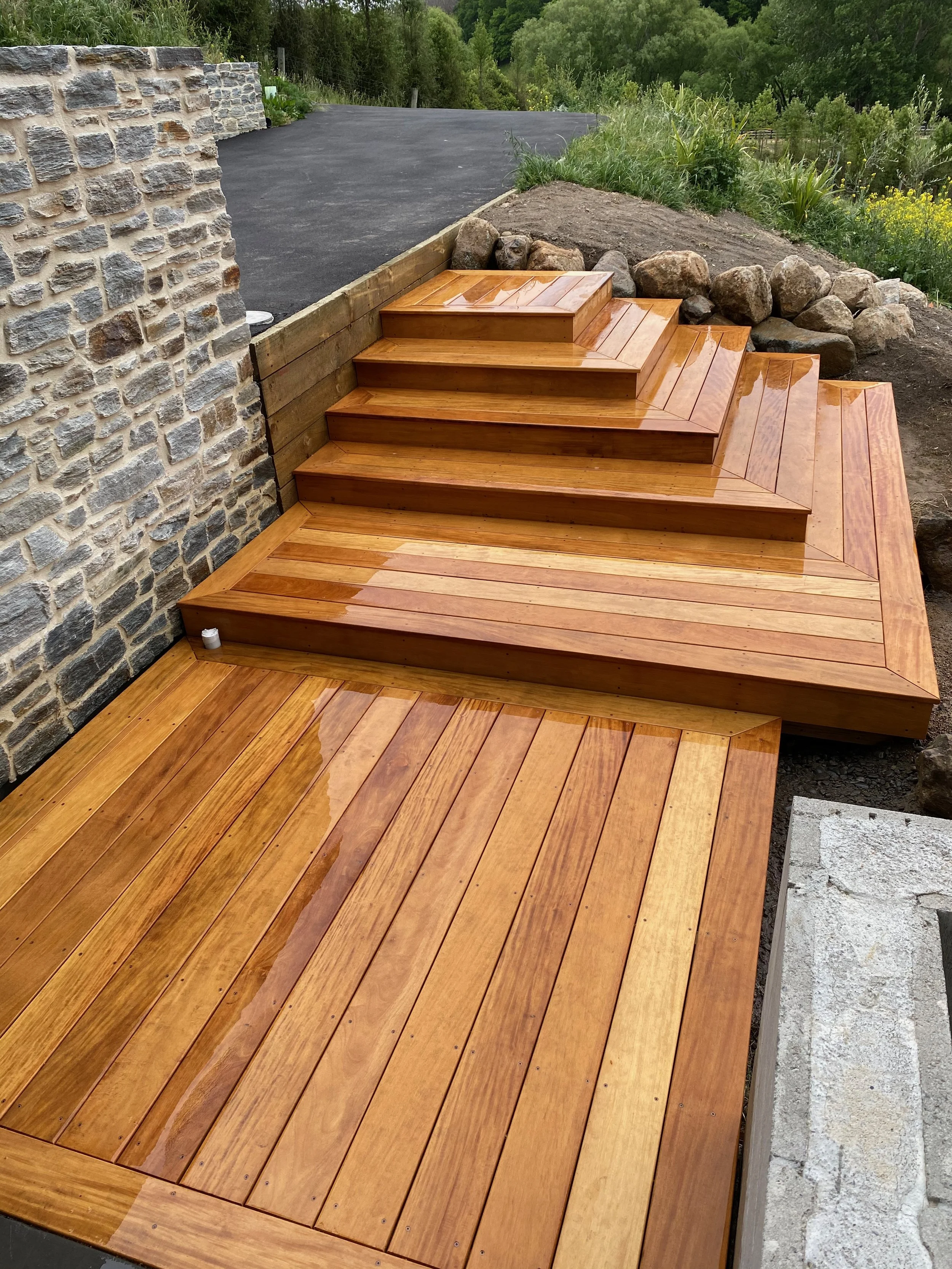 A custom square steps and deck build on a sloping section for a stunning hillside home in Christchurch.