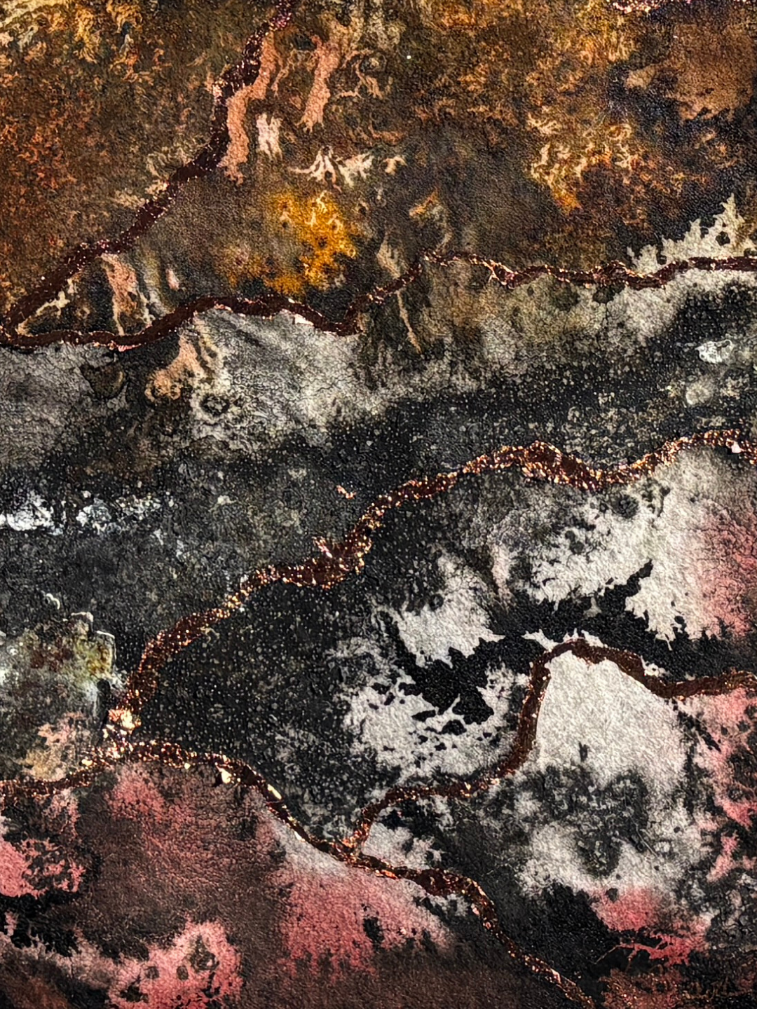 Close-up of the textured surface of one of Kate Brown's artworks  with blacks, grays, earthy tones and warm terracottas, highlighted with thin, glowing copper leaf lines which evoke root growth.