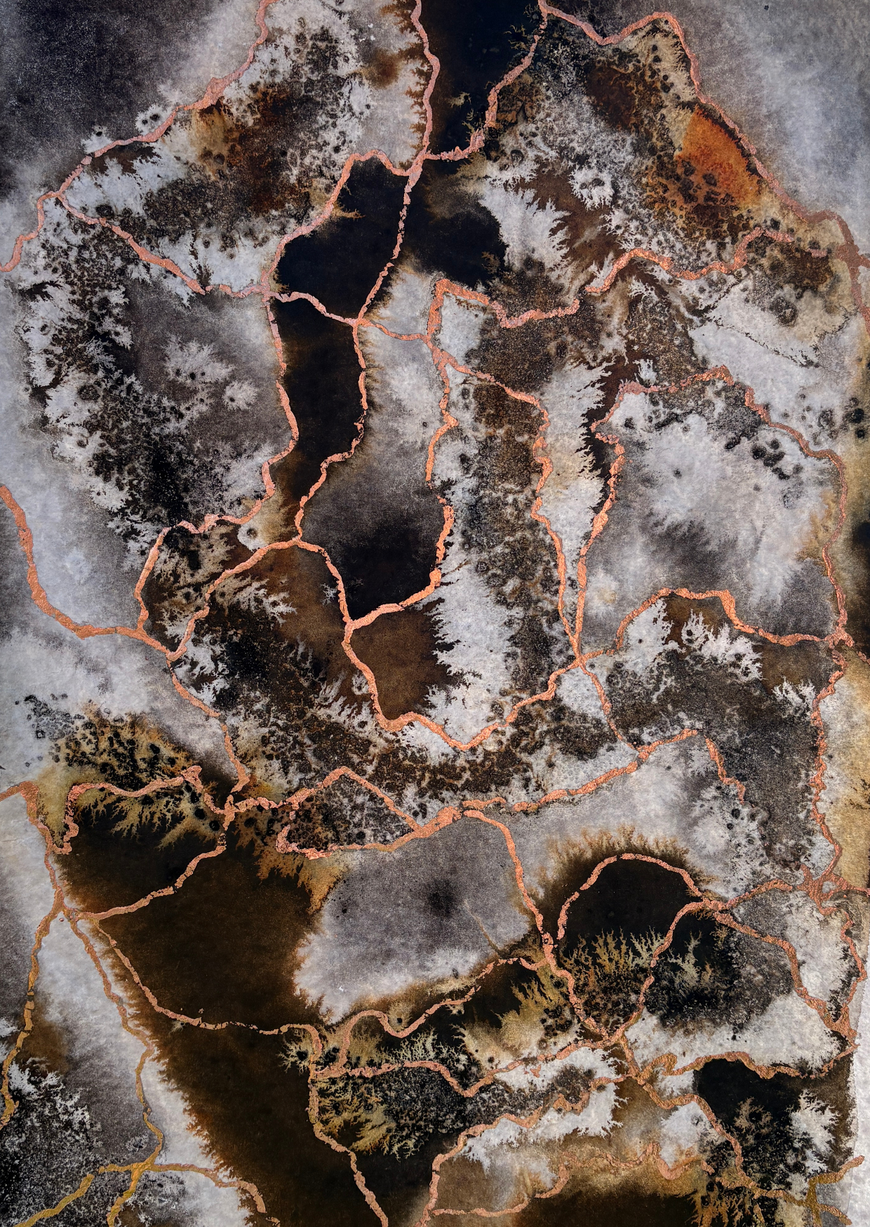 A contemporary, abstract art work on paper. Featuring Earthy tones of browns agains more subtle use of whites and greys, suggestive of terrain viewed from above. Irregular lines of copper cross the surface and each other like rhozomes.