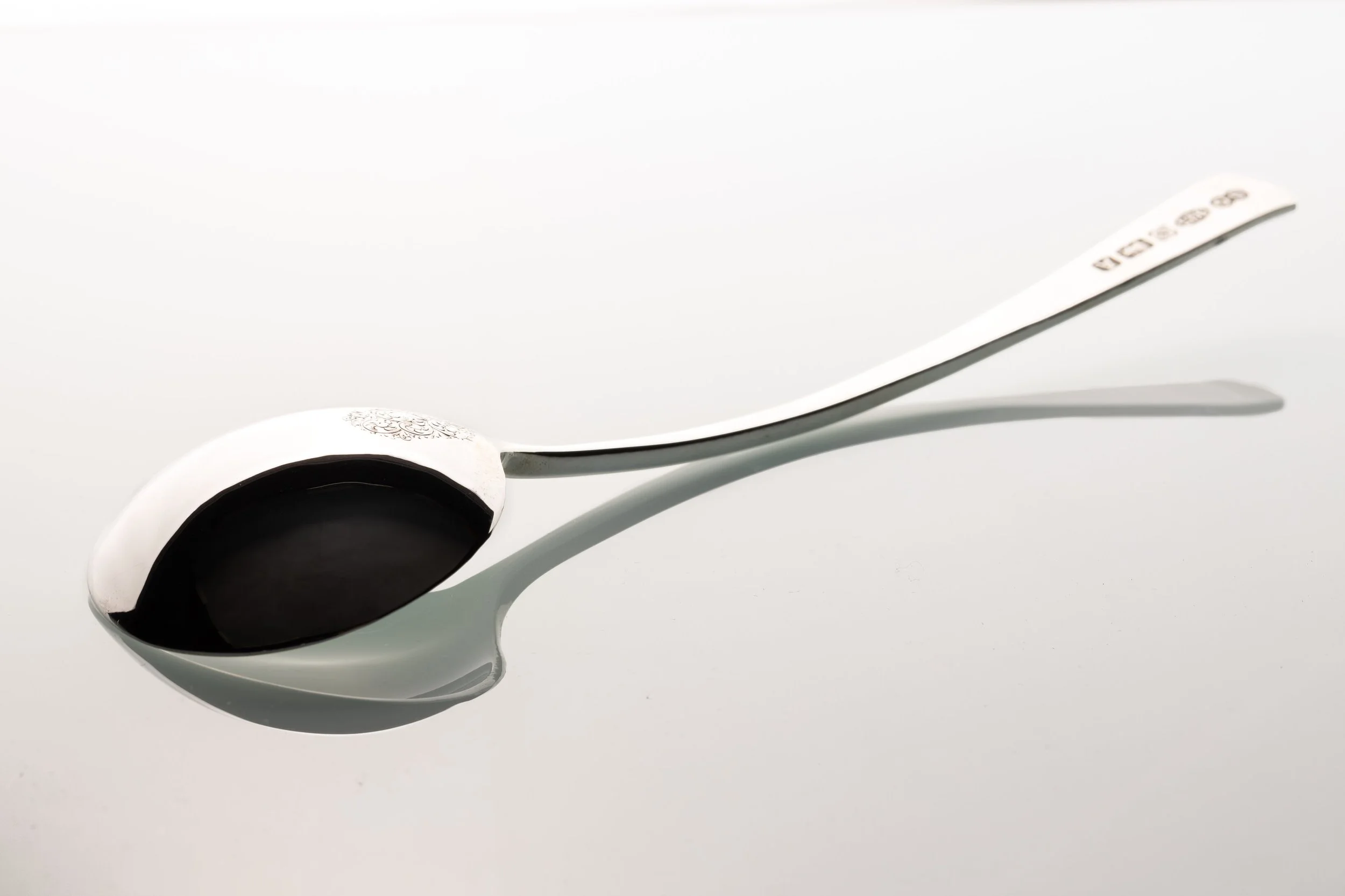 A sterling silver spoon handmade by silversmith Harry Stokes.