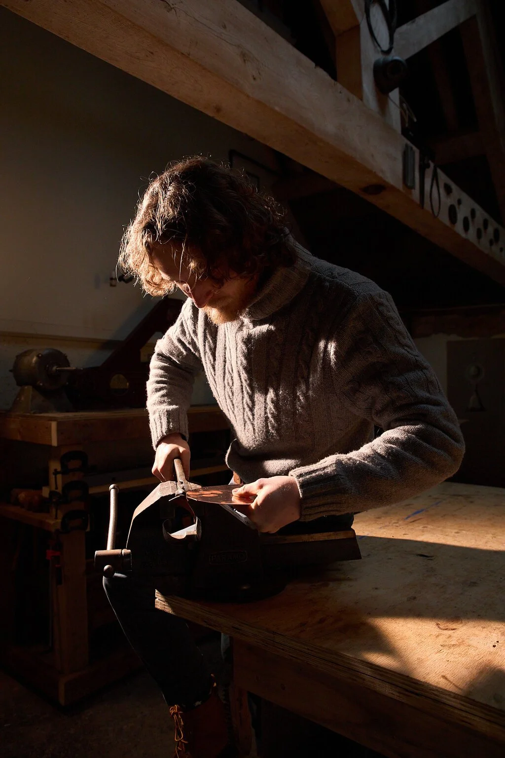 English silversmith Harry Stokes working in his workshop on the edge of the Cotswolds.