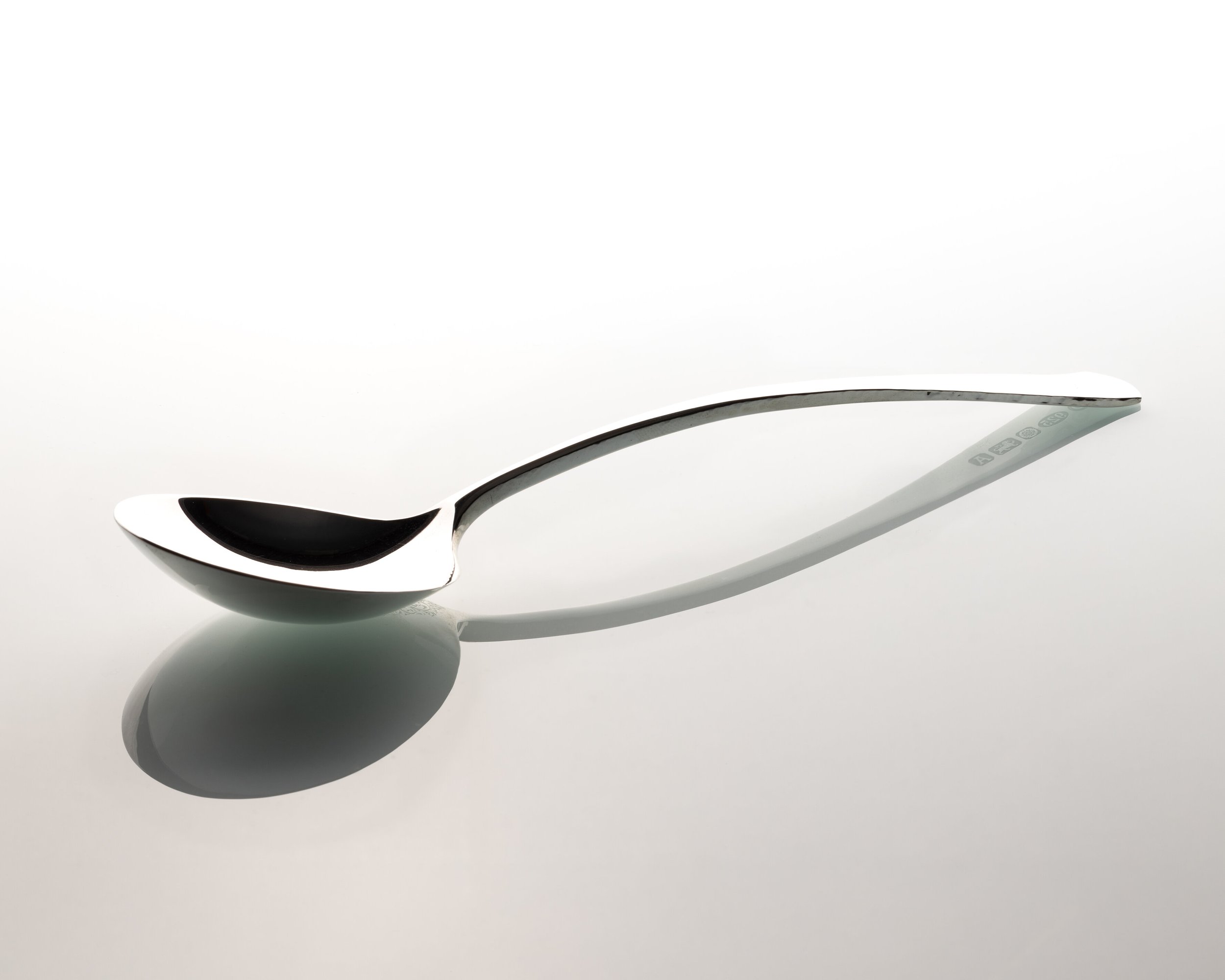 A sterling silver spoon by silversmith Harry Stoke.