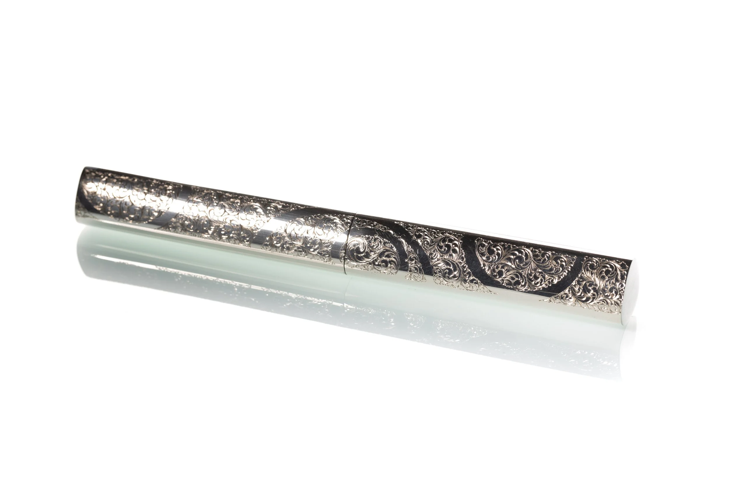 A sterling silver case engraved with a bespoke filigree design by silversmith Harry Stokes.