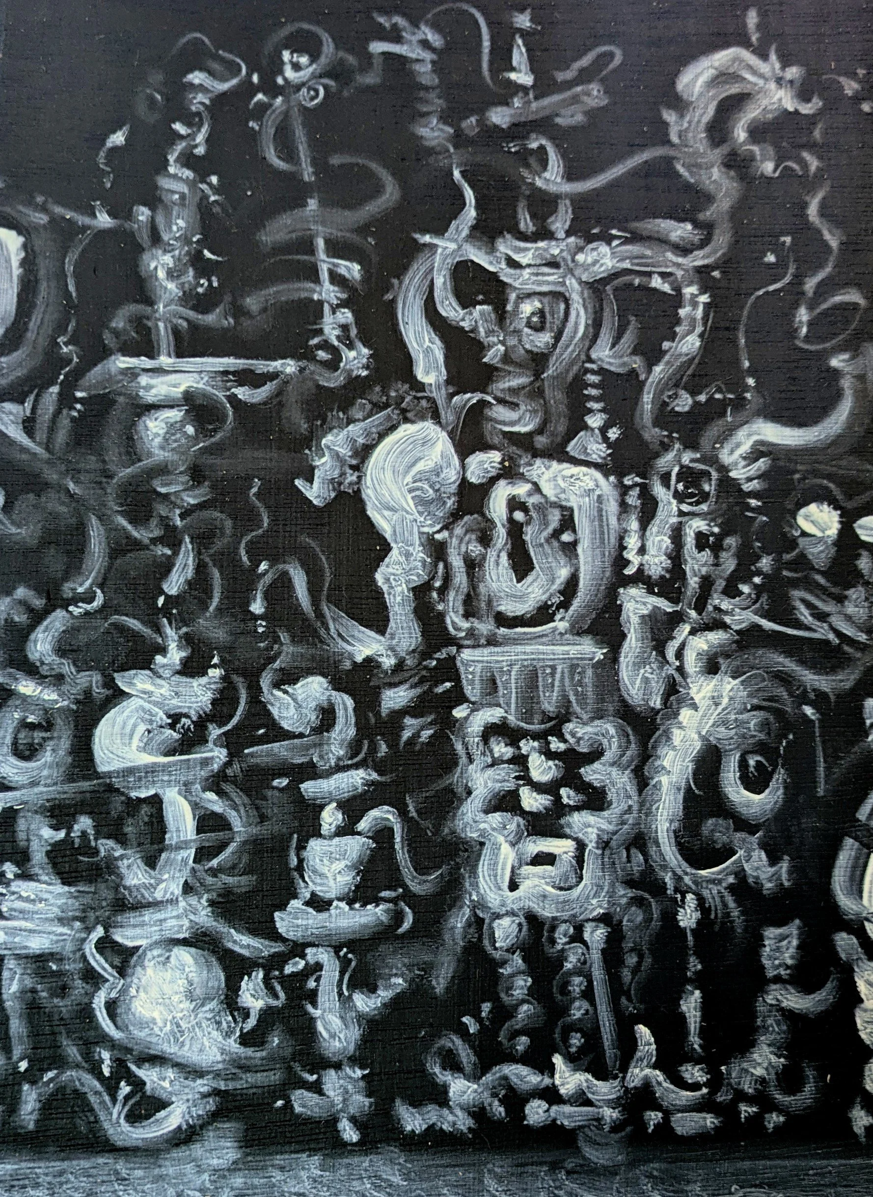 White chalk used to write symbols and scribbles on a black chalkboard.