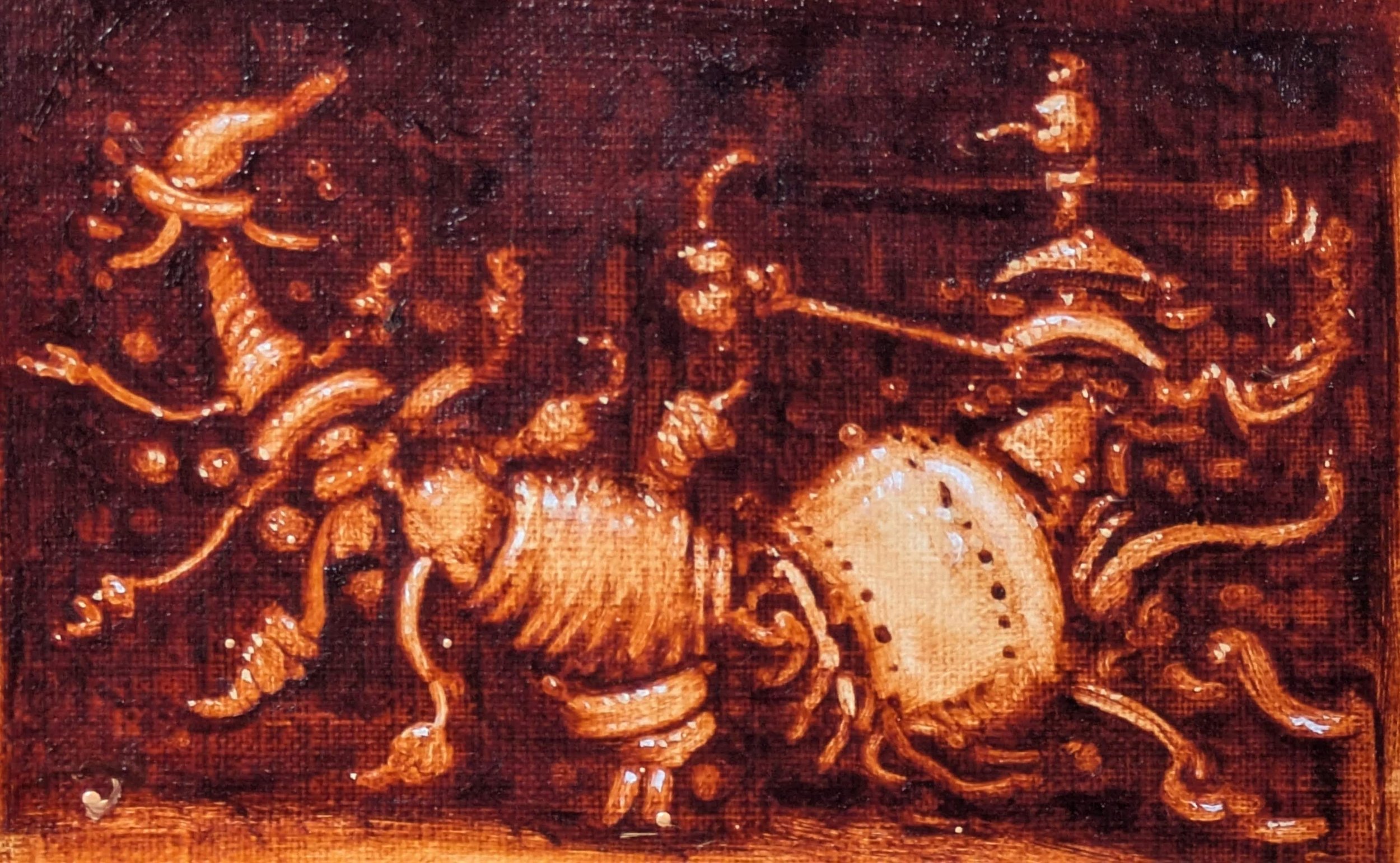 Close-up of a detailed, gold-colored engraving of a decorative scene featuring a horse and ornate swirling patterns on a reddish-brown background.