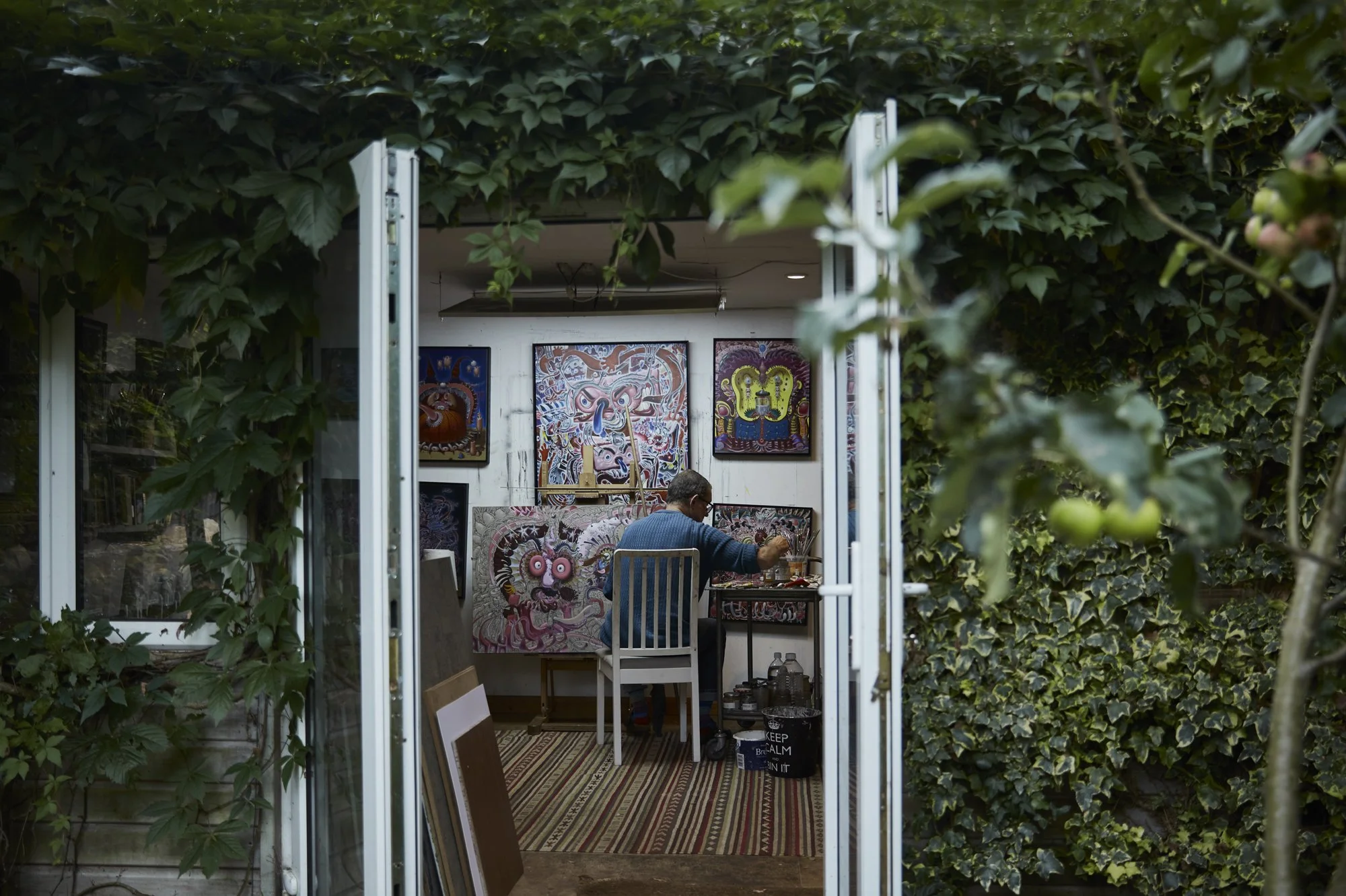 photograph of a painting inside a studio through a doorway