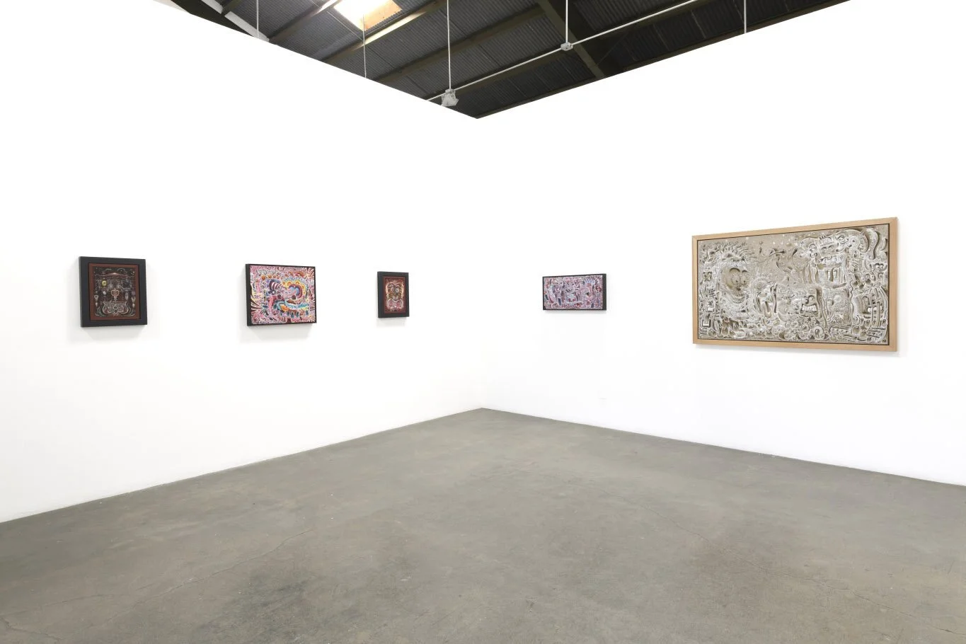 Gallery with five paintings on a white wall, including one large artwork on the right, and a concrete floor.