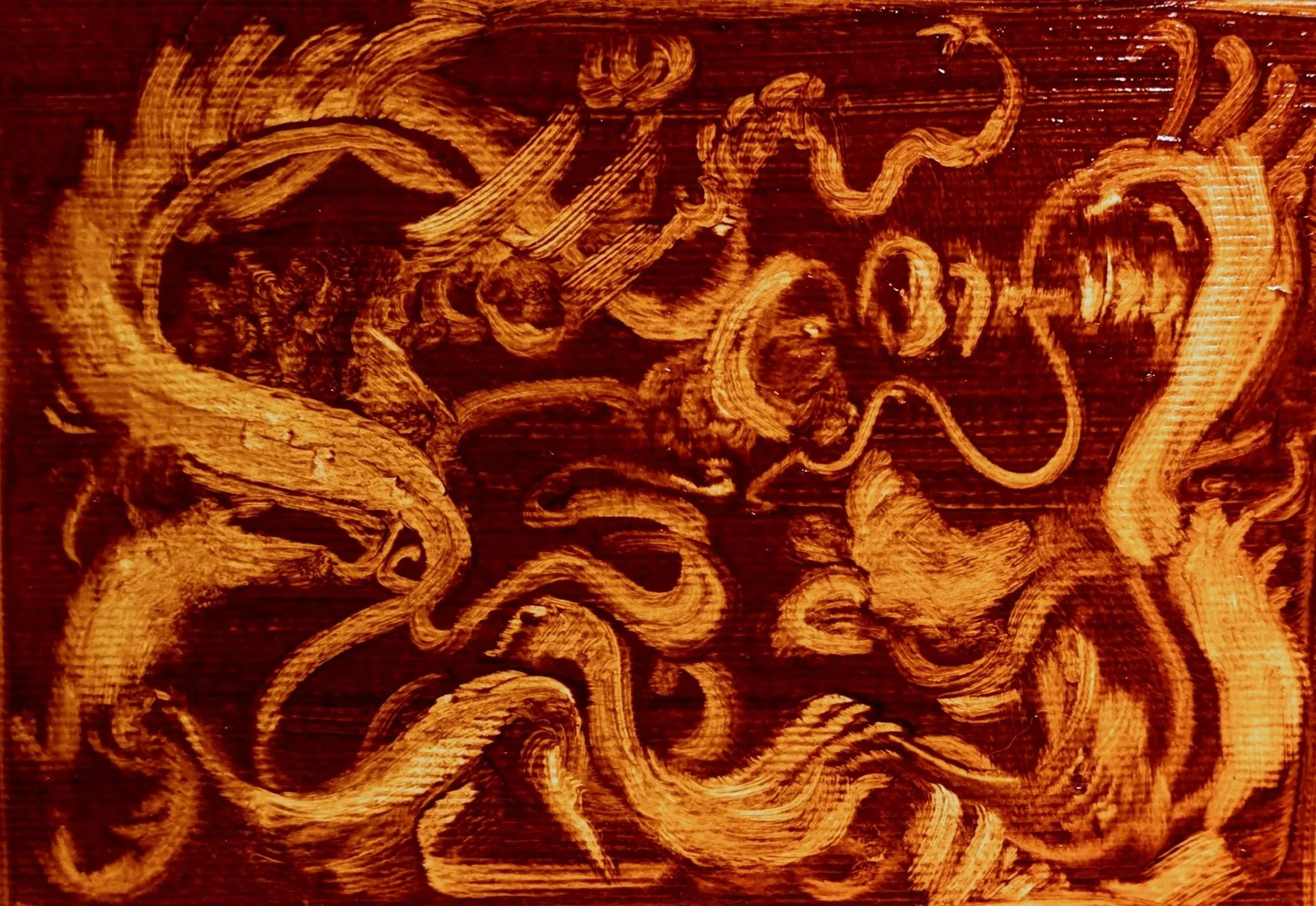 Close-up of a wooden surface with intricate carvings or swirling patterns.