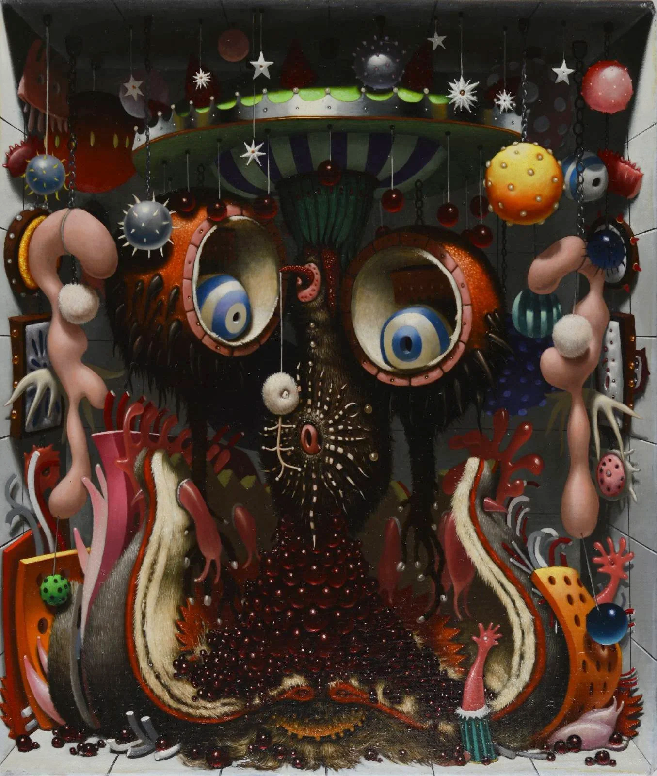 A colorful, abstract art installation featuring various shapes and textures resembling organic and alien-like forms, with a central focal point of large eye-like structures and hanging decorative elements.