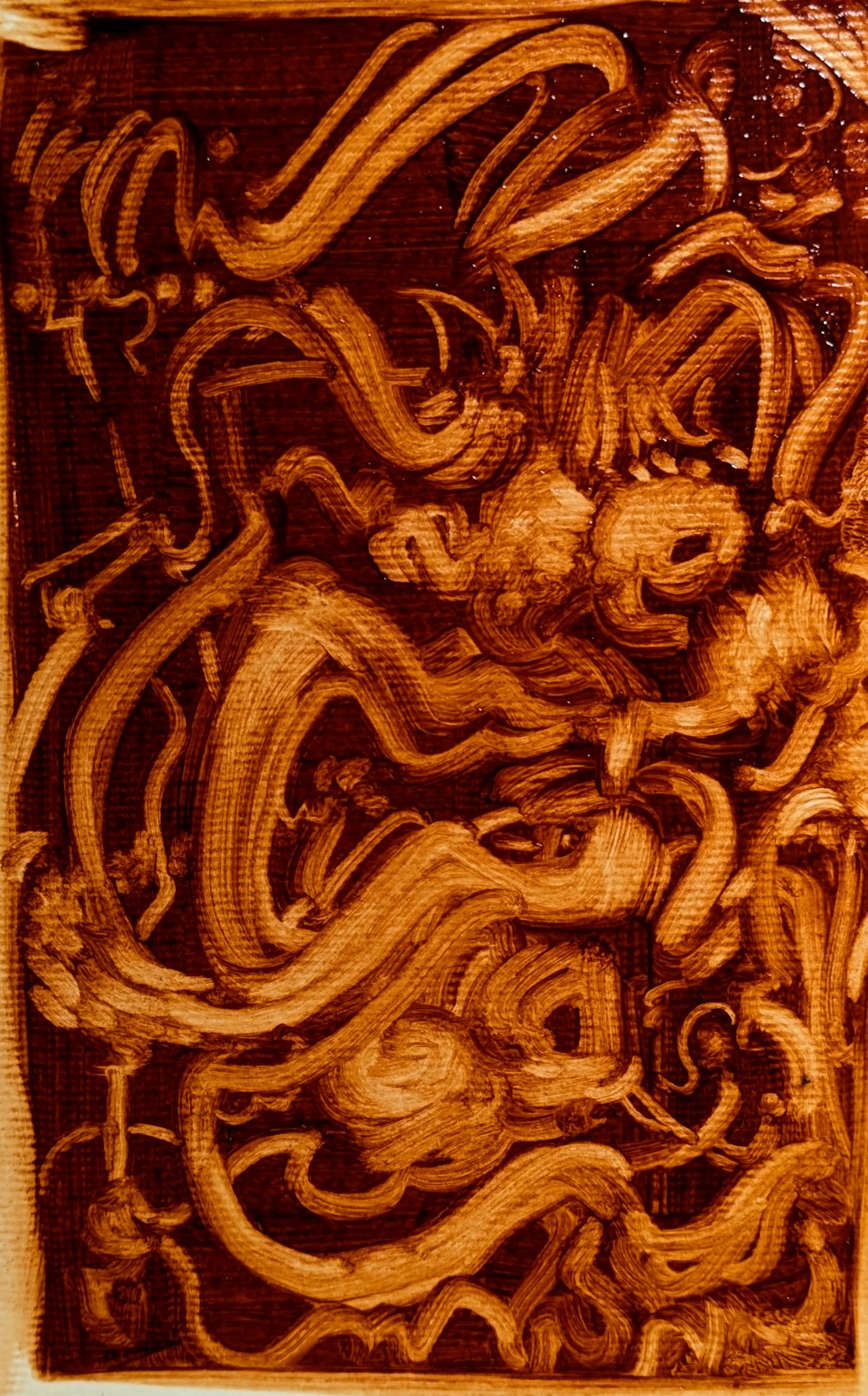 Intricate wood carving with swirling patterns and abstract designs in a rich brown finish.