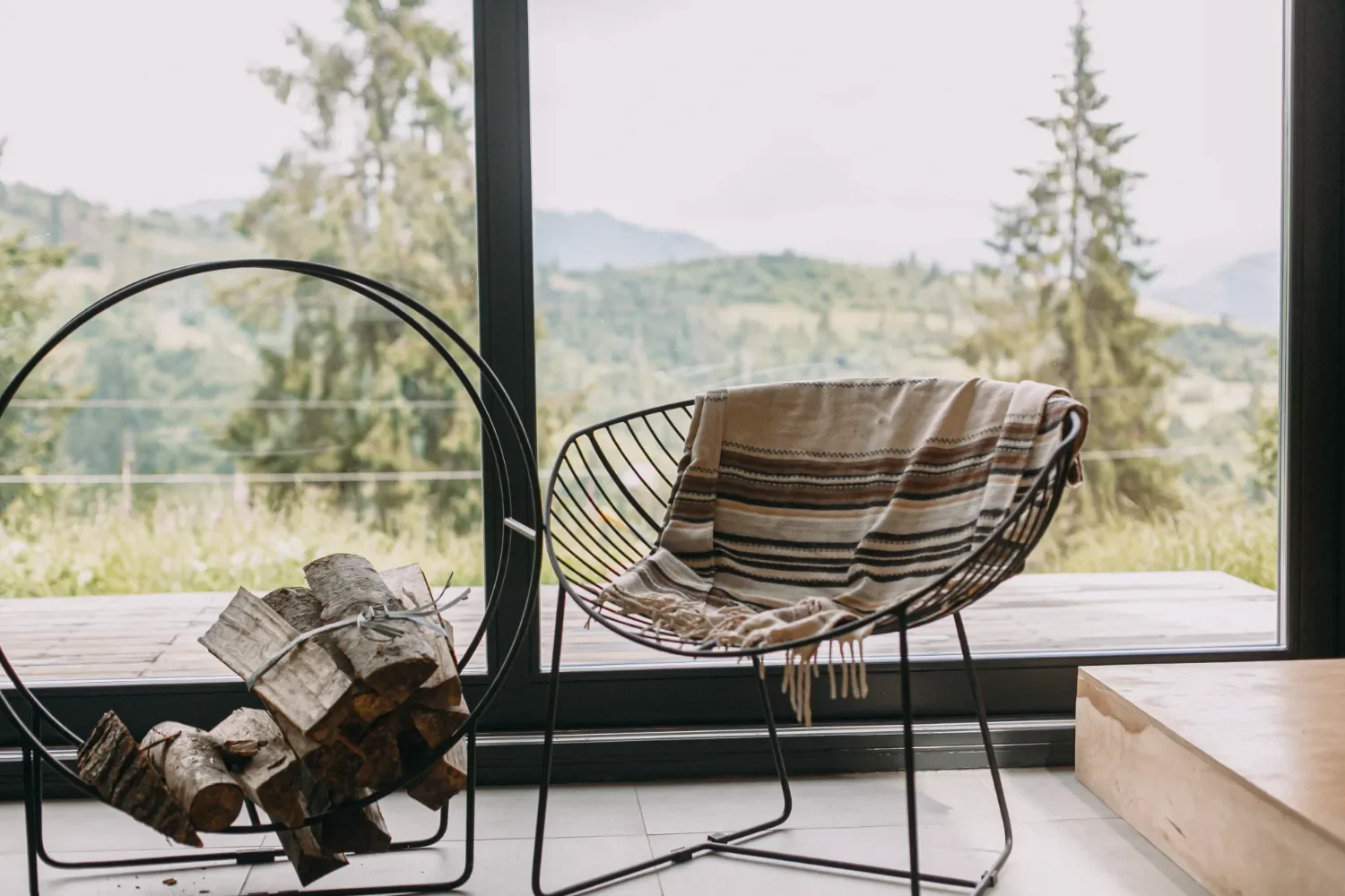 Metal frame chair in front of a large window