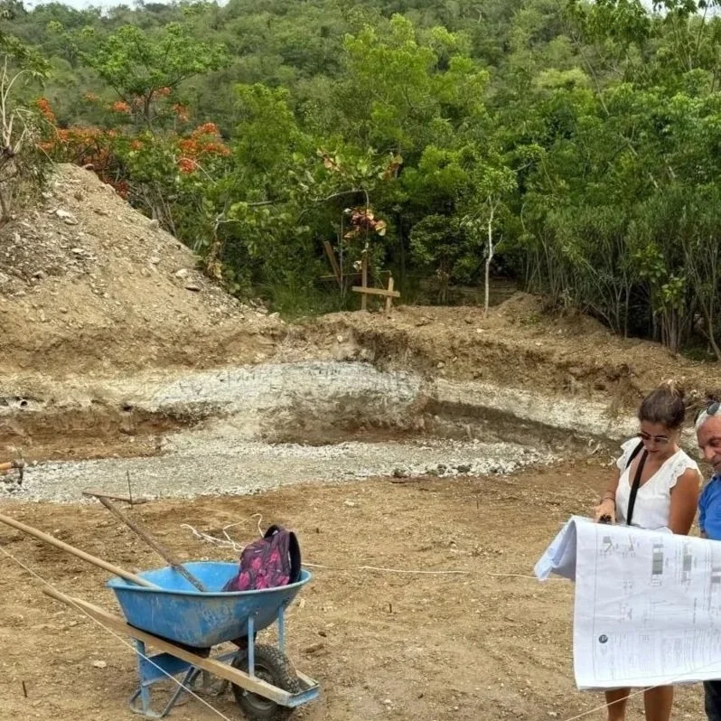 Two people looking at a  plan during a construction site