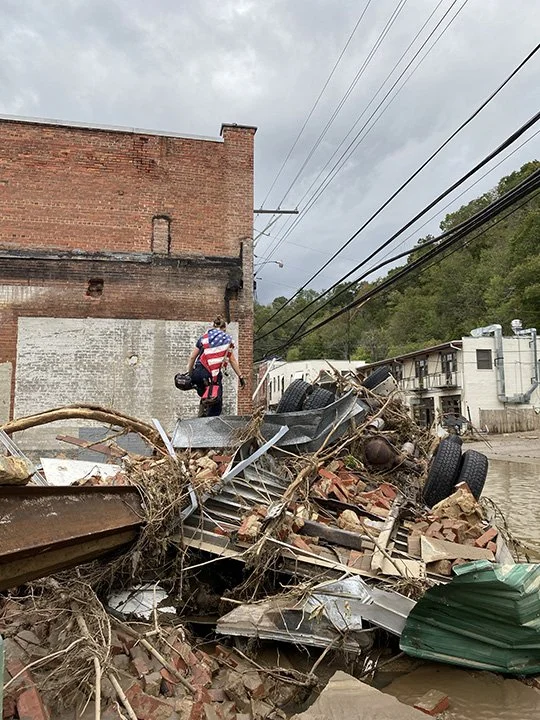 A first responder on the wreckage of the building next to the Police Station and City Hall