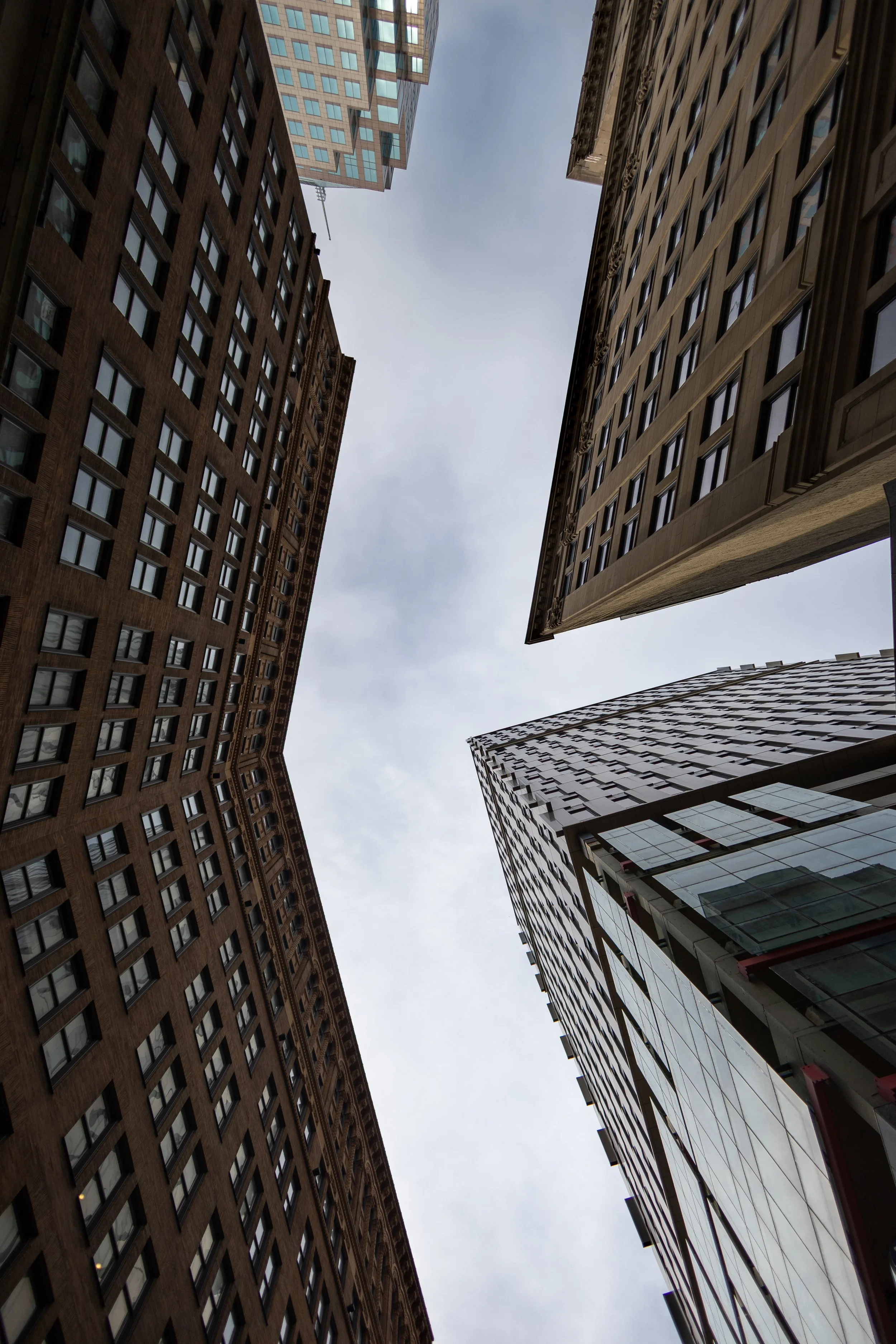 Looking up at tall skyscrapers in an urban city.