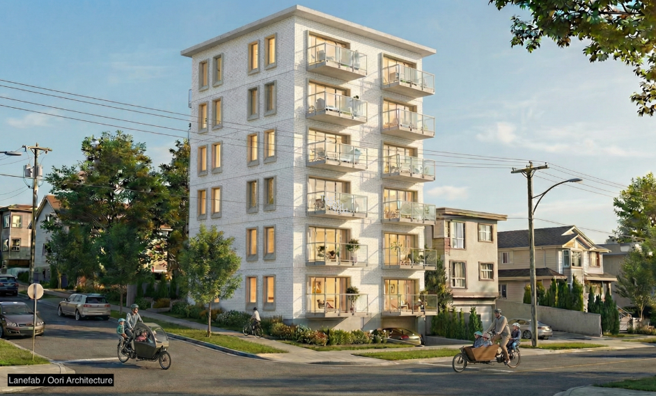 A modern, multi-story residential apartment building with balconies, surrounded by trees and neighboring houses, with people riding bikes on the street.