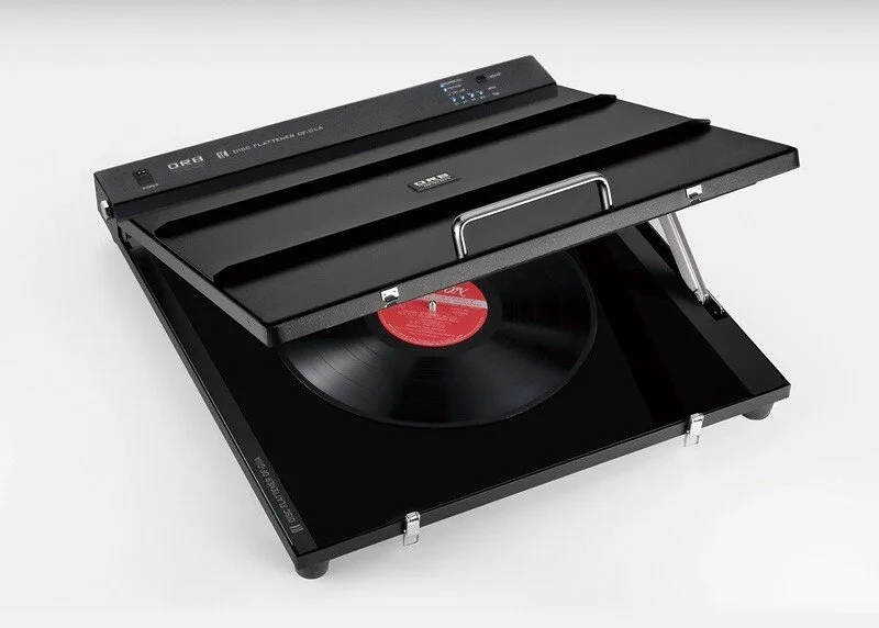 A black vintage record player with a spinning vinyl record on it.