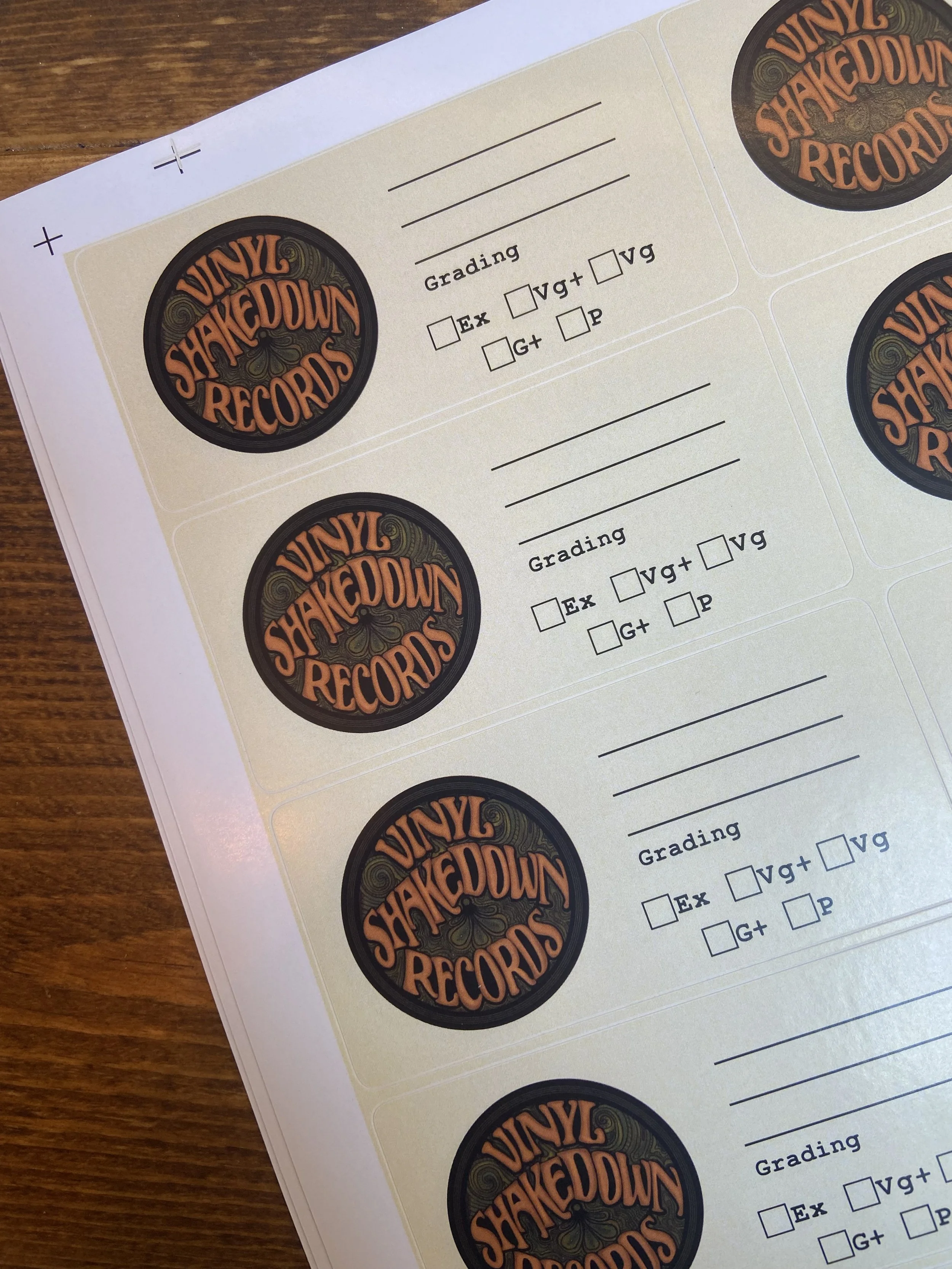 Close-up of a sticker sheet with multiple vinyl records labeled 'Vinyl Shackdown Records' and space for grading information.