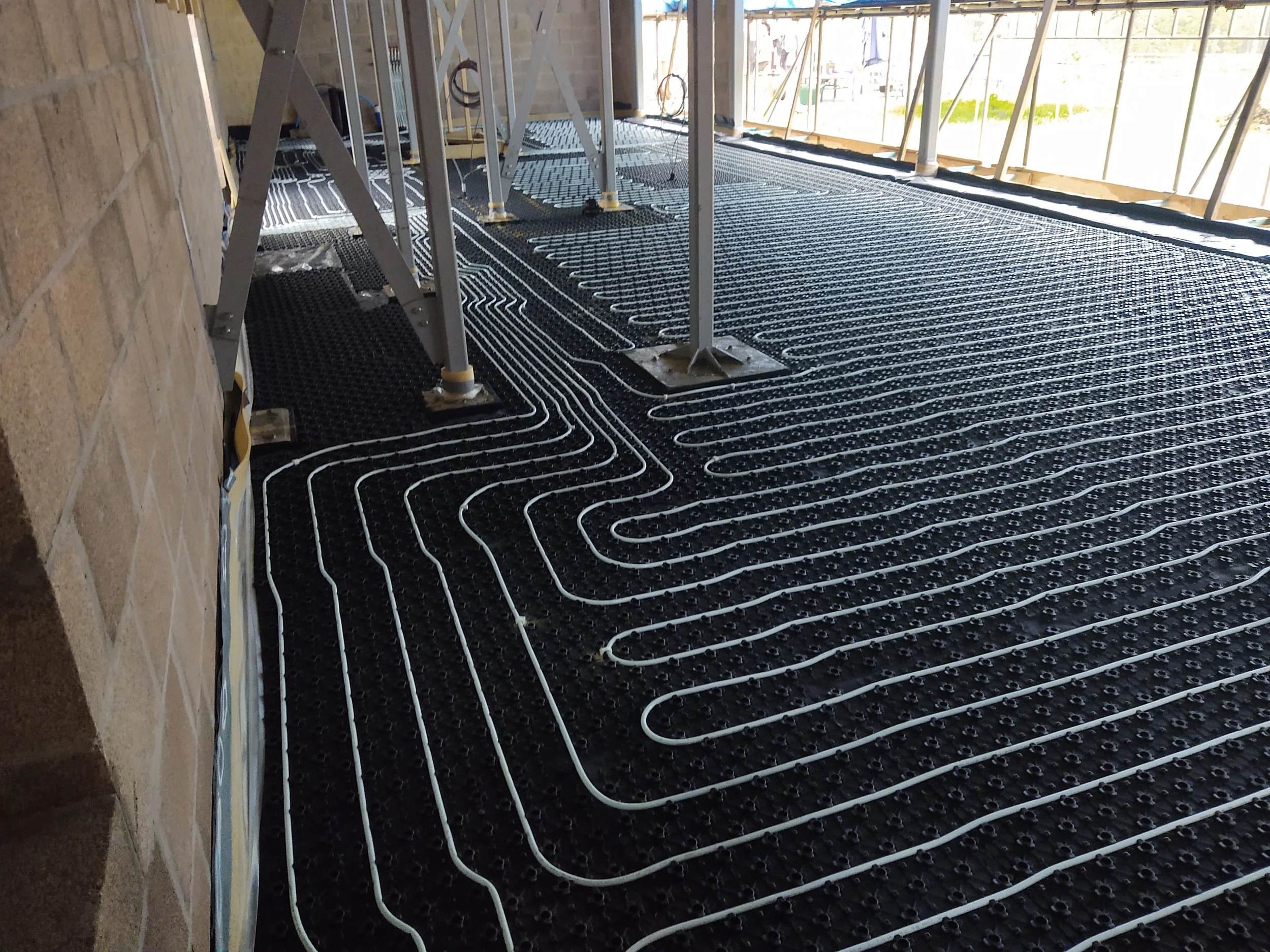 Under floor heating pipes installed in a property before the floor has been laid.