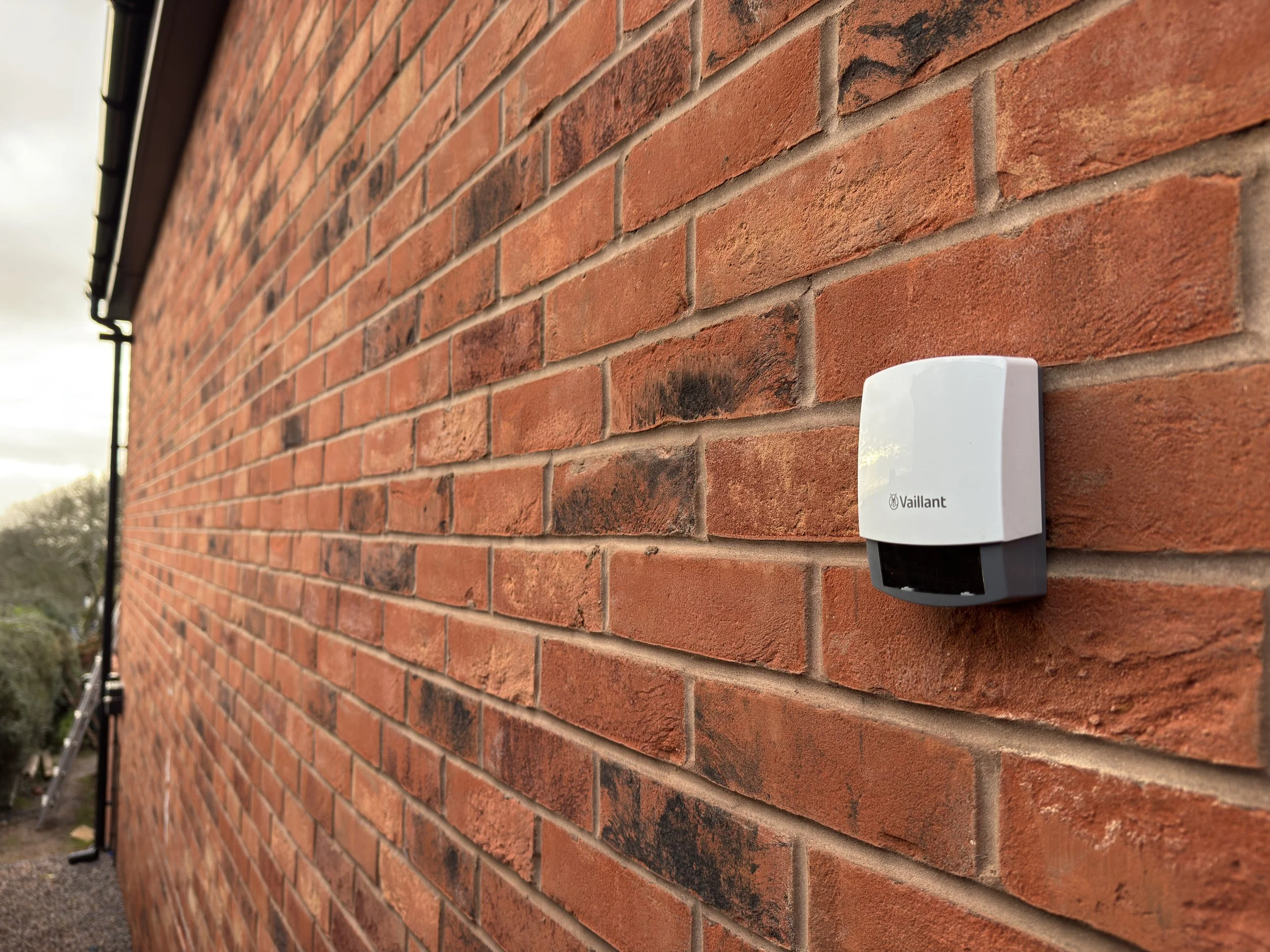 Vaillant heat pump outdoor sensor on a brick wall
