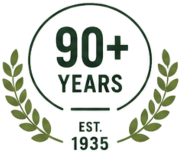 A logo celebrating over 90 years since 1935, featuring a green laurel wreath surrounding the text '90+ Years' and 'Est. 1935' in black.