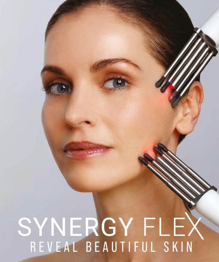 Close-up of a woman receiving a facial treatment with multiple microcurrent devices applied to her face, promoting skin rejuvenation available at Elvy Beauty, Thirsk, North Yorkshire, UK.