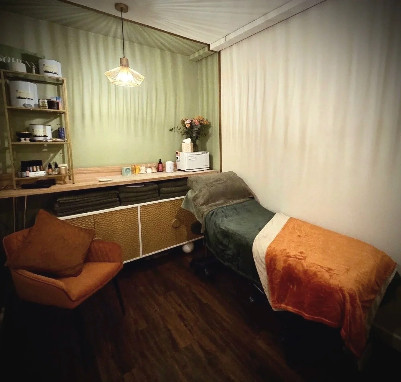 A warmly lit comfortable treatment room at Elvy Beauty of Thirsk, North Yorkshire, UK where customers can receive premium beauty, skin care and nail treatments including CACI synergy non-invasive treatment.