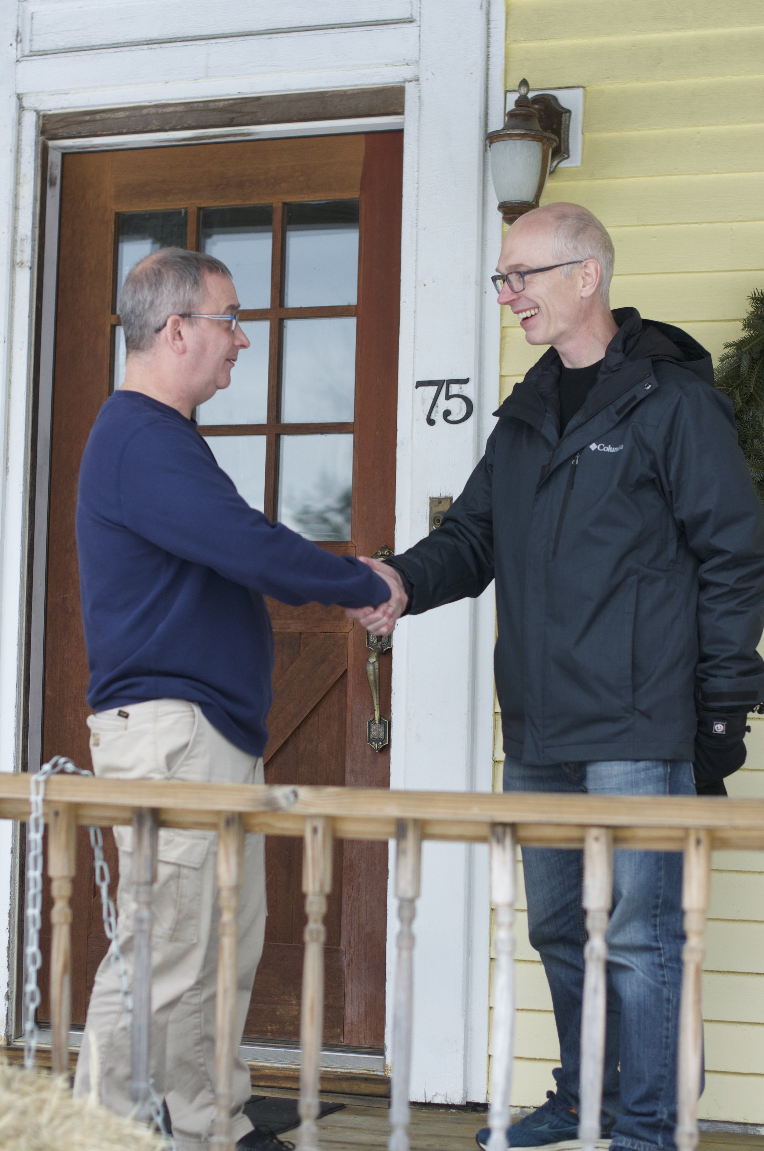 Dana Staples Auburn Maine House of Representatives district 88 Two men shaking hands on a porch, outside a house with the number 75.