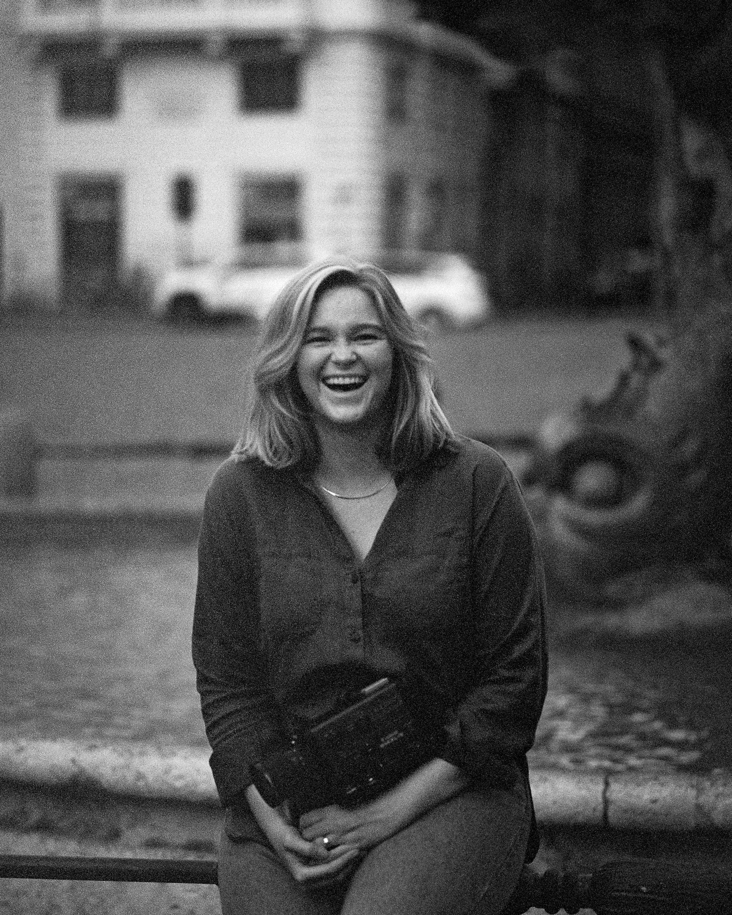 super 8 filmmaker laughing while holding super 8 camera