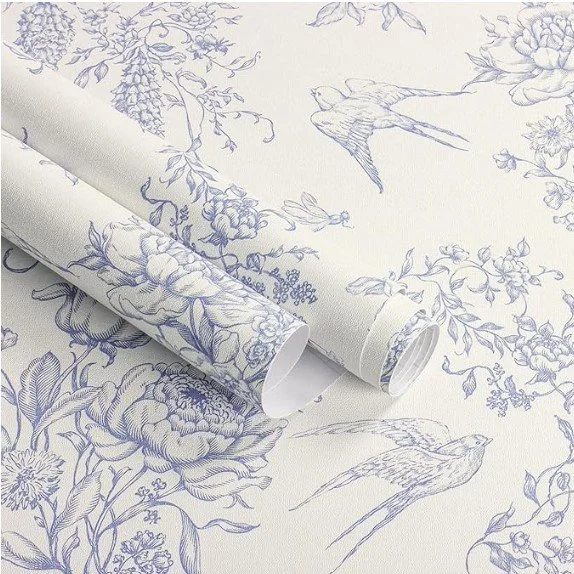 Rolls of wallpaper with a floral and bird pattern in blue on a white background.