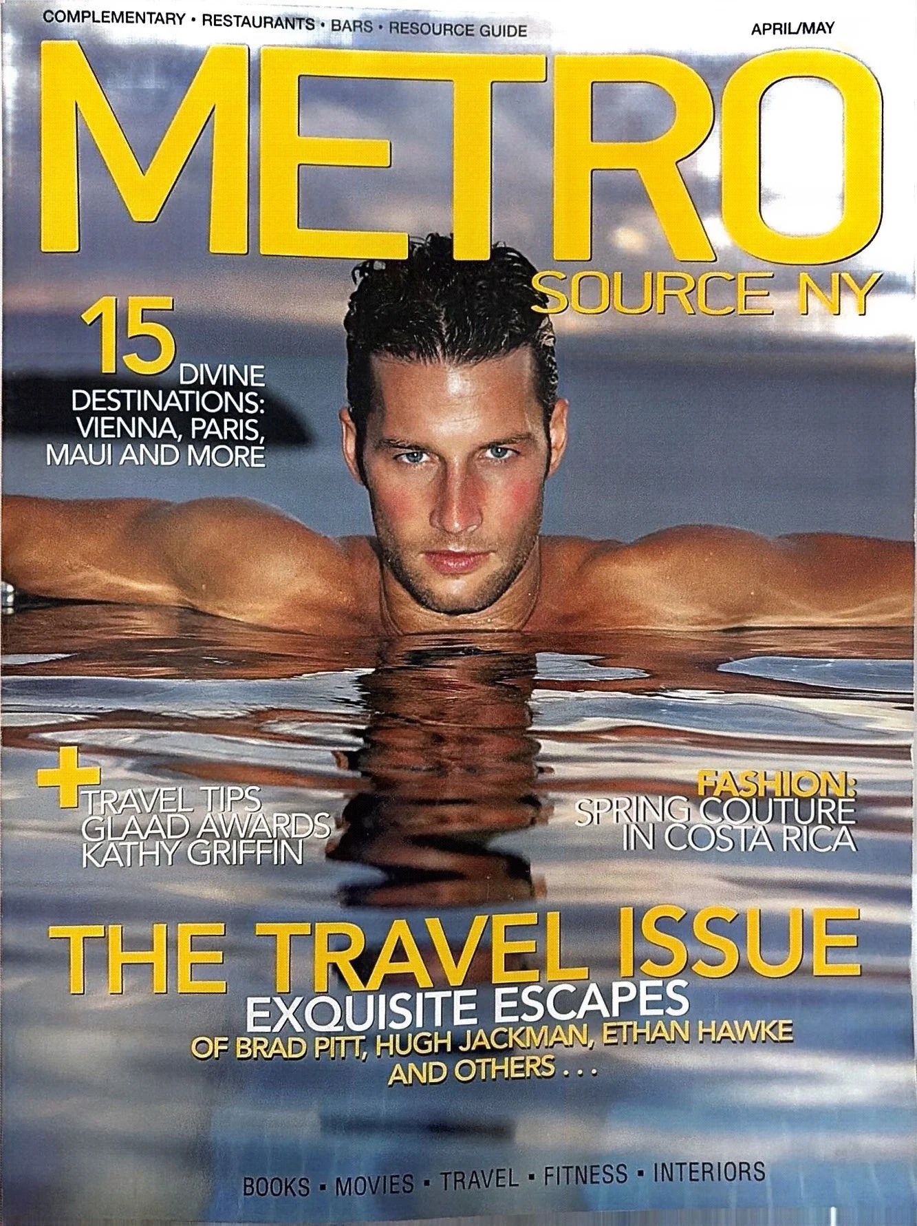 Magazine cover titled "METRO SOURCE NY" from April/May. Features a man with wet hair in a swimming pool, resting his arms on the water surface, with clouds and sky in background. Headlines mention travel destinations, fashion, and travel tips.