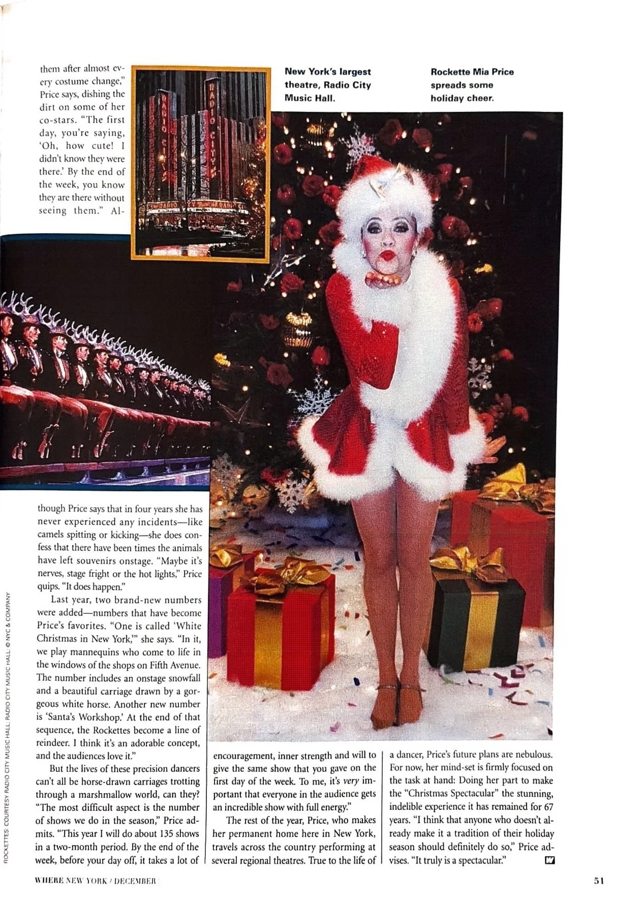 A woman dressed as a Christmas character in front of a decorated Christmas tree with presents underneath. She is wearing a red and white costume with fluffy trim, and has white hair styled in a wild manner. She is making a playful pose with her lips puckered and her hand near her face. The background includes a decorated Christmas tree with ornaments and lights.