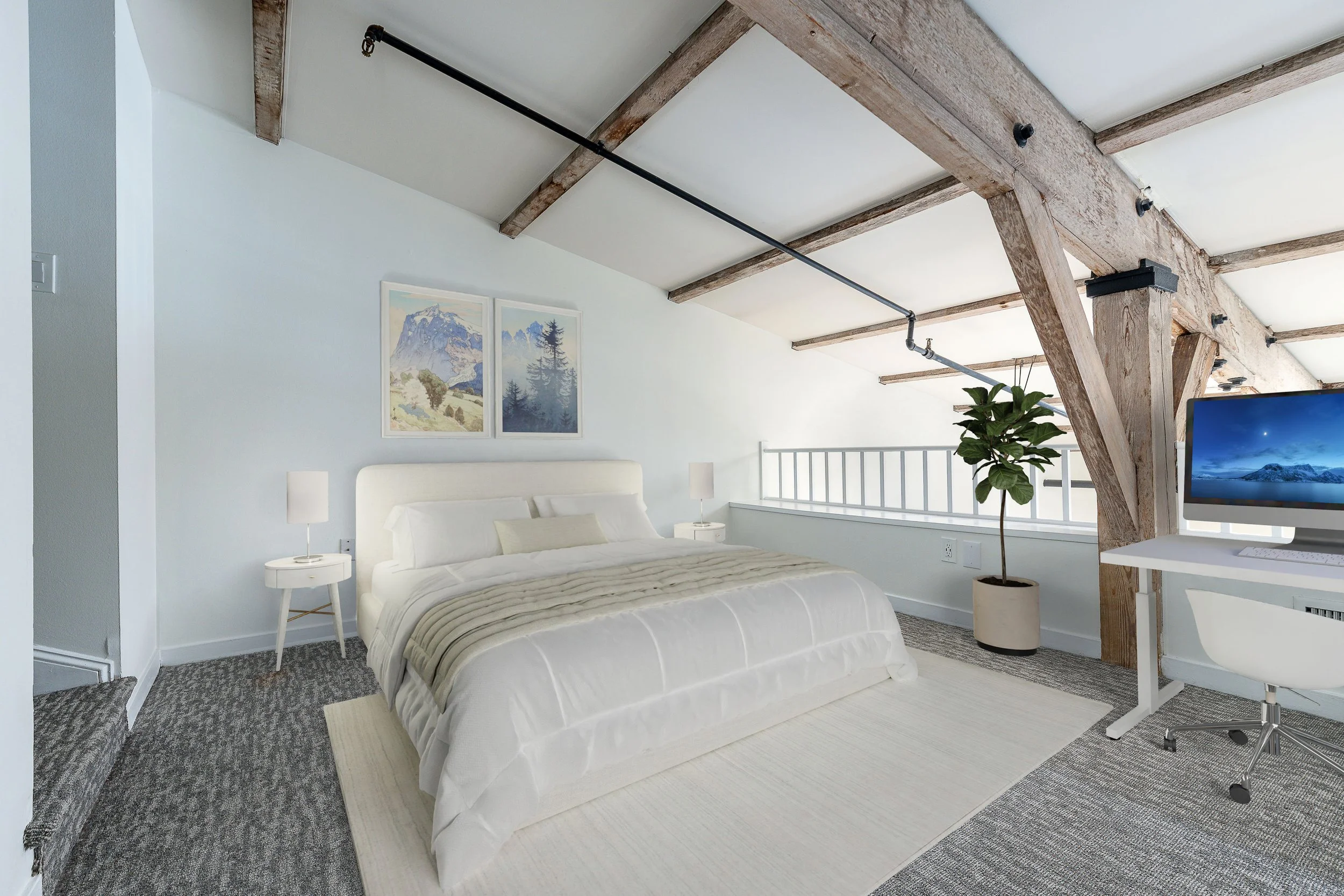 Modern bedroom with white bed, side tables, and artwork, featuring exposed wooden beams and a desk with a computer, a potted plant, and a railing.
