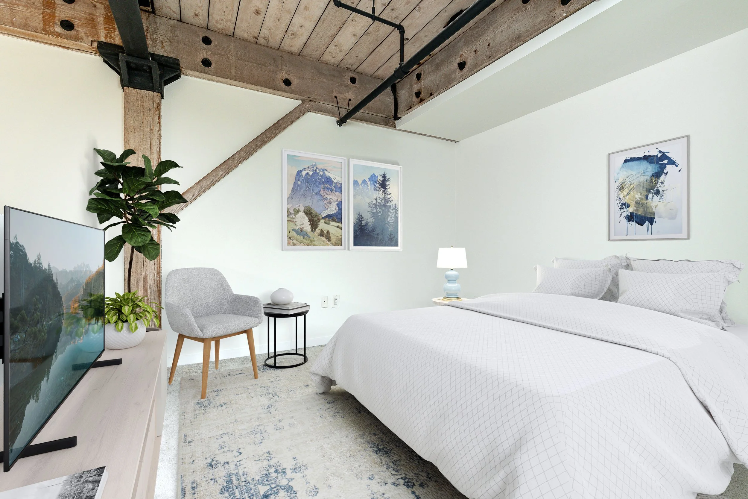 A bedroom with a white bed, artwork on the walls, a lamp, a chair, a TV, and plants, in a room with exposed wooden beams and white walls.