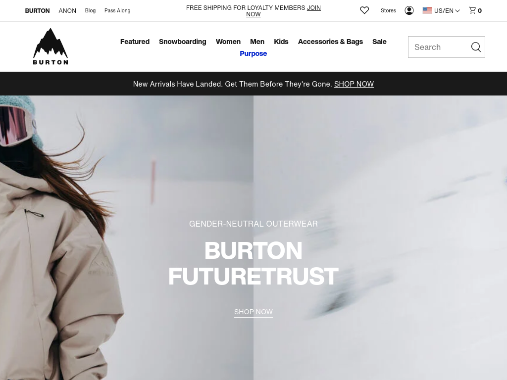 Website homepage screenshot for Burton, showcasing a person in a beige snowboard jacket with a hood and goggles, standing in a snowy landscape, advertising gender-neutral outerwear.