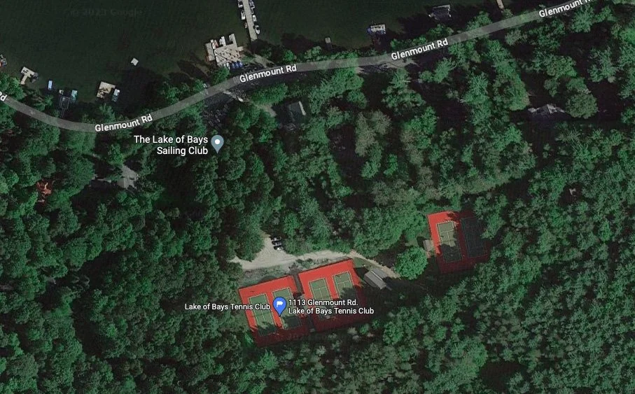 Aerial view of a wooded area with two tennis courts and a building labeled Lake of Bays Tennis Club, located near Glenmount Road with a nearby sailing club at the lake.