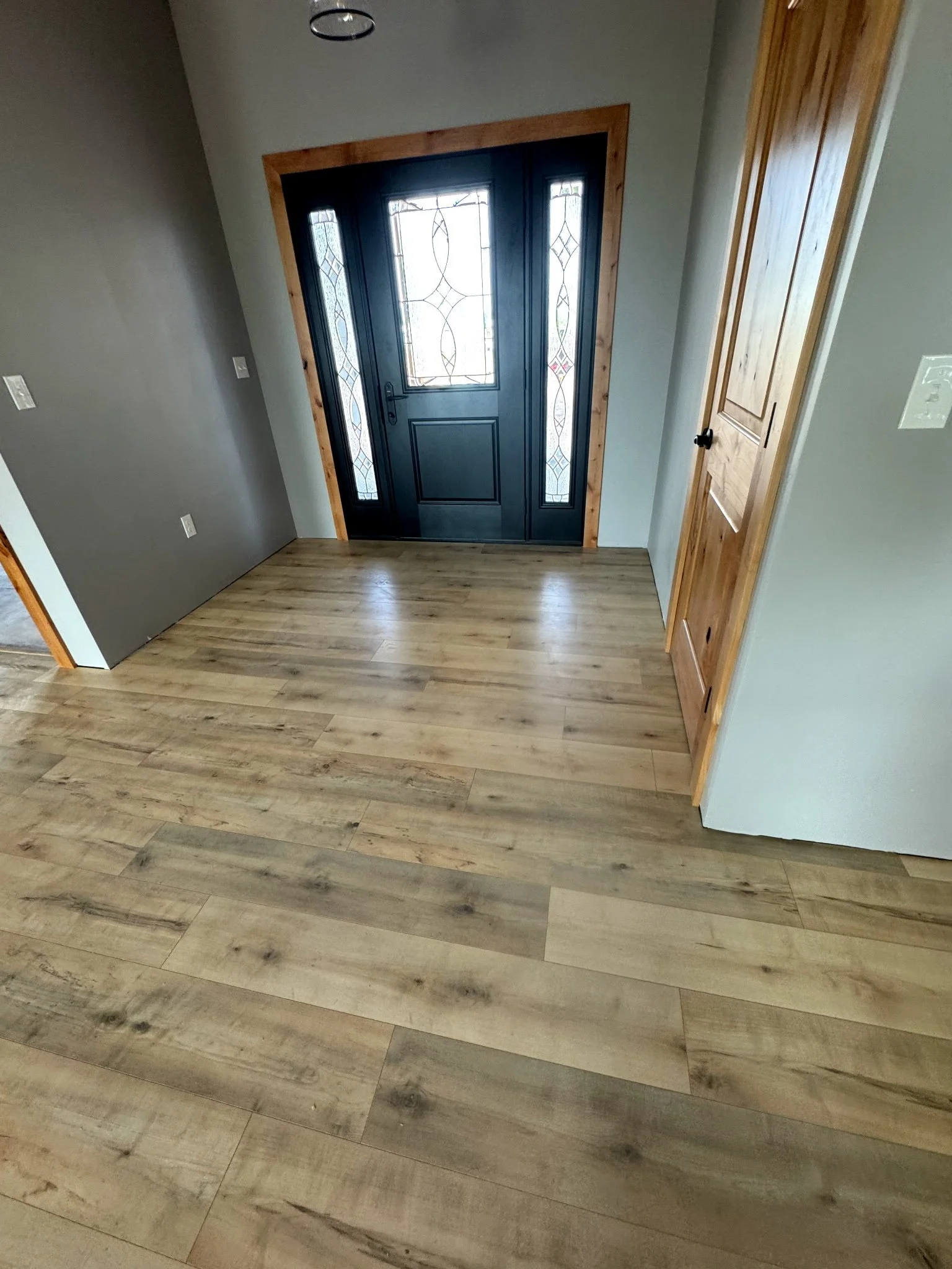 Large entry way with beautiful hardwood floors installed by Northwest Home Innovations.