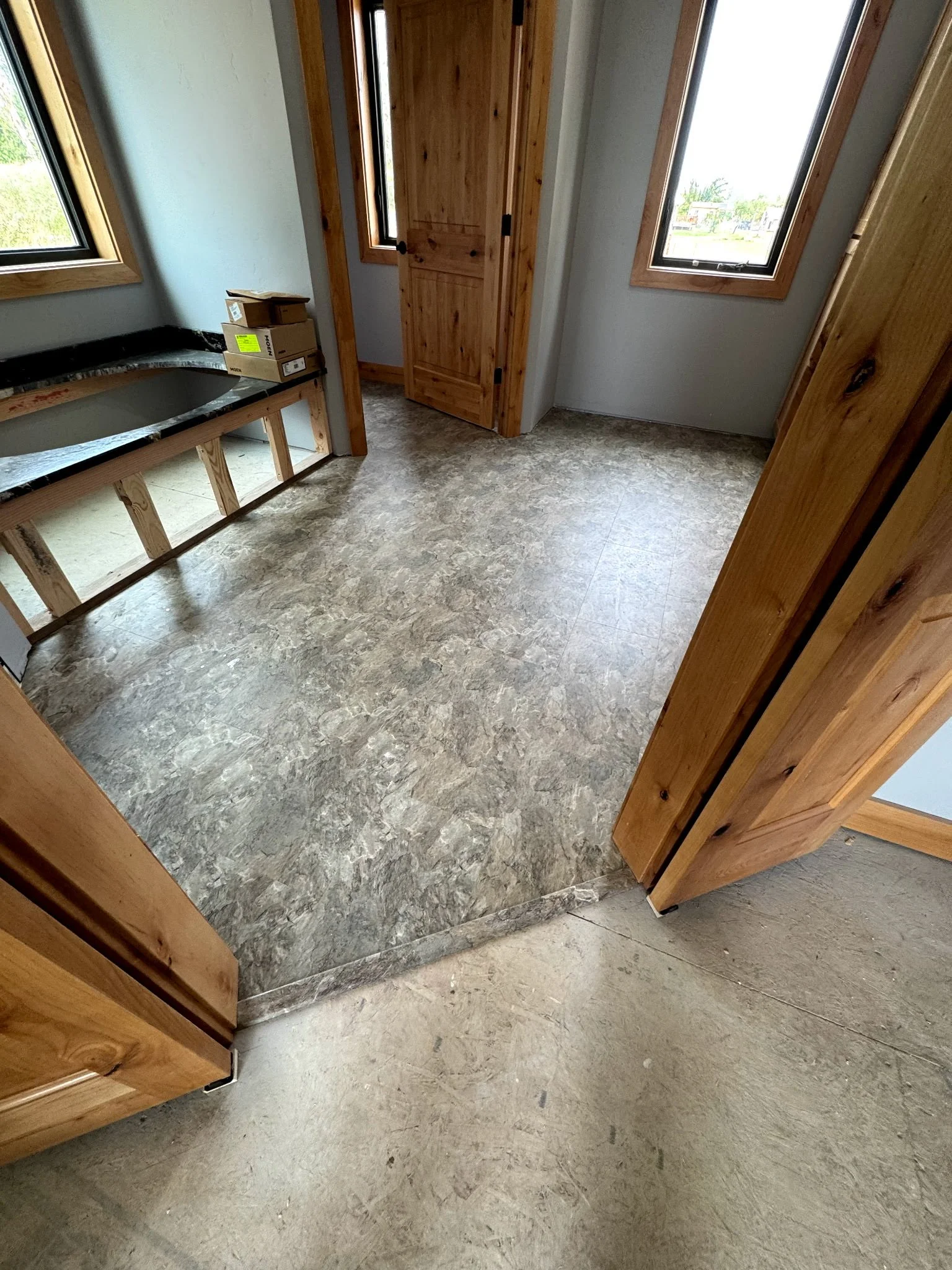Wood flooring and detailed entryway created by Northwest Home Innovations.