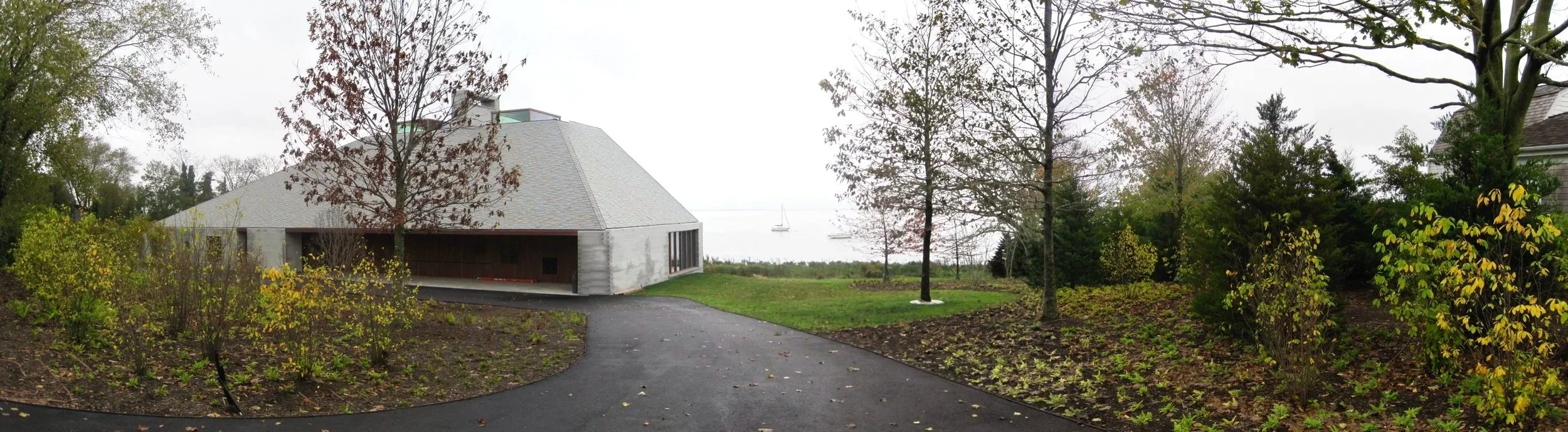 Layered native plantings frame driveway at private modern residence, coastal Long Island.