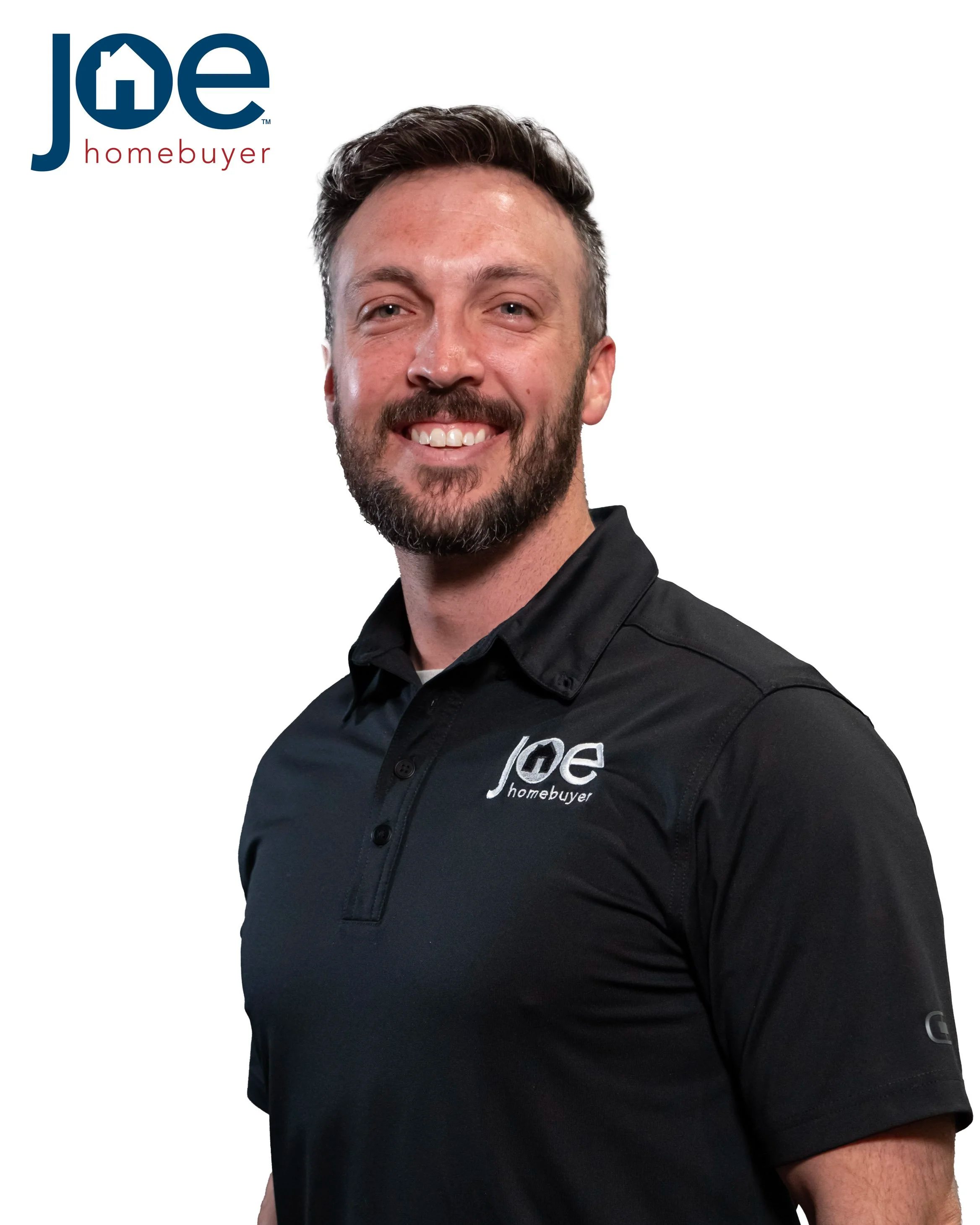 A smiling man with a beard wearing a black polo shirt with the Joe Homebuyer logo, standing against a plain background.